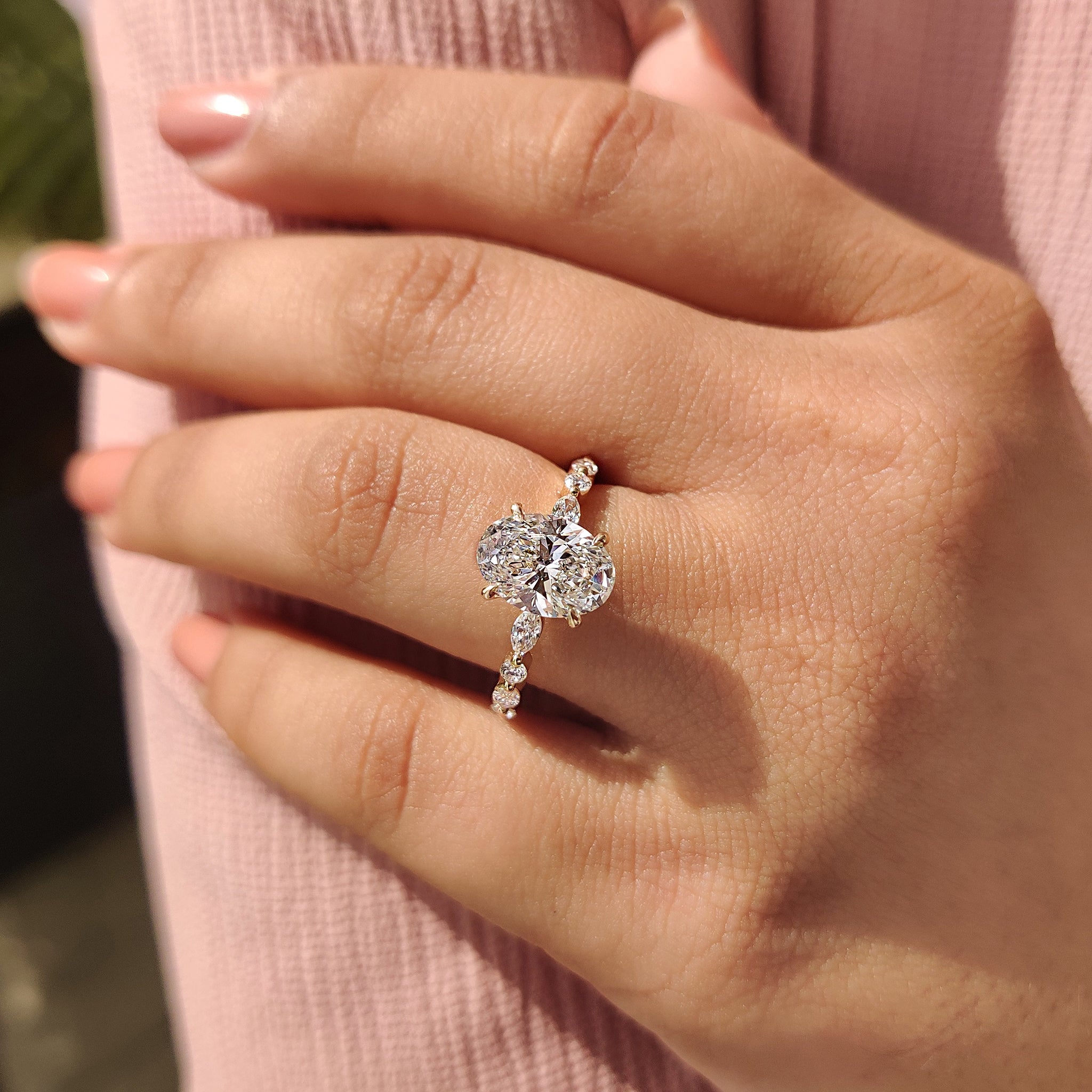 Oval cut diamond ring with marquise and round band