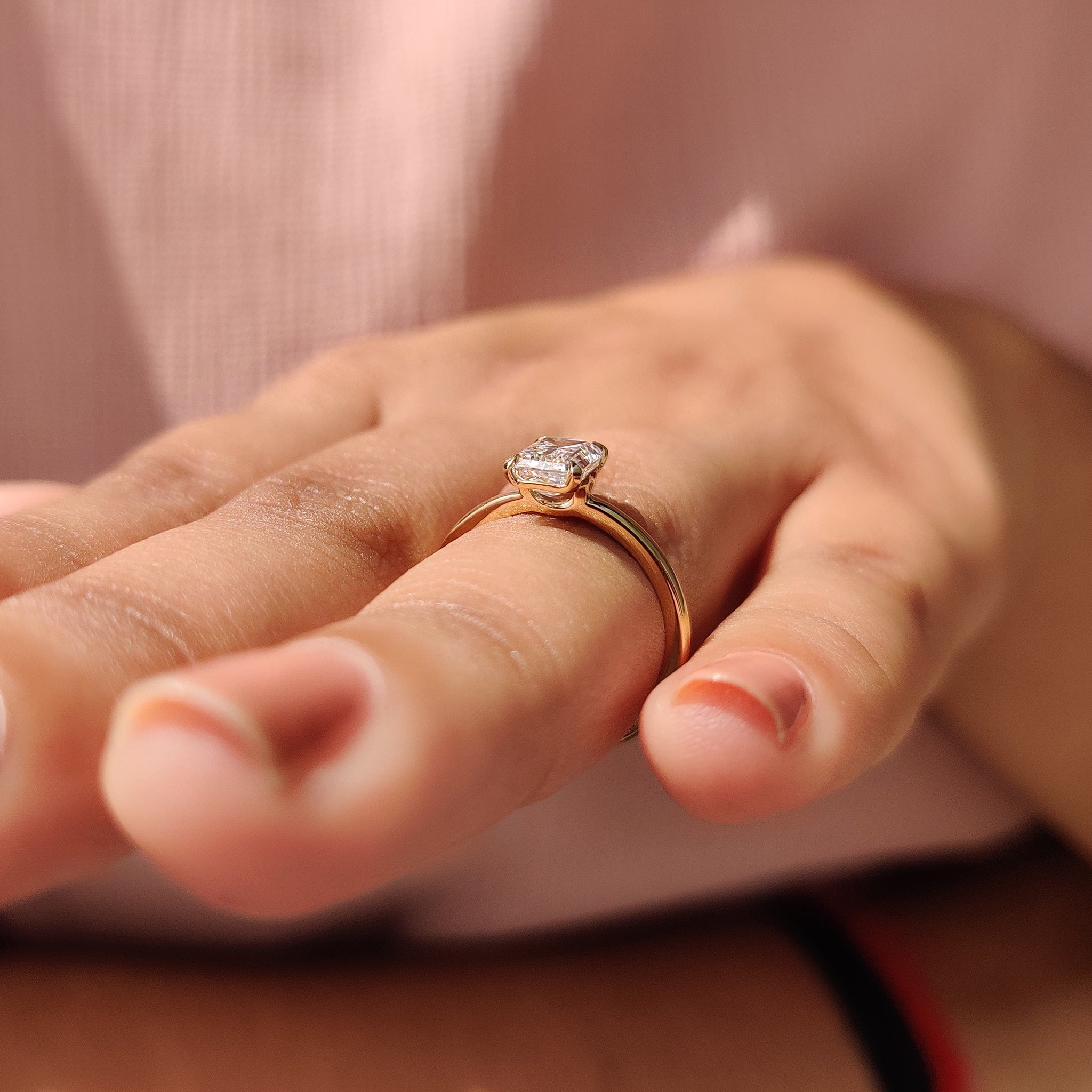 Four claw prong emerald cut diamond ring