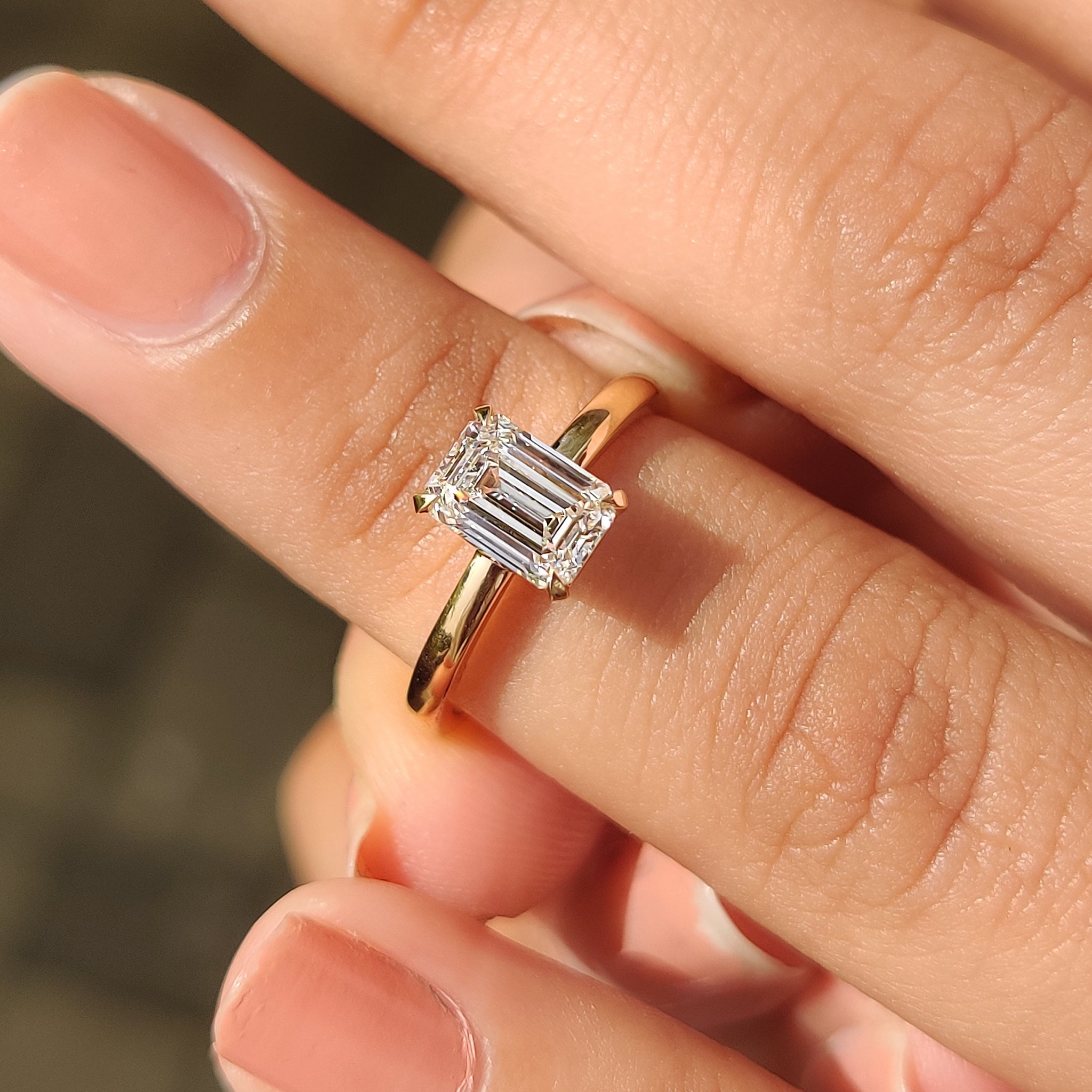Emerald cut diamond ring with prong setting
