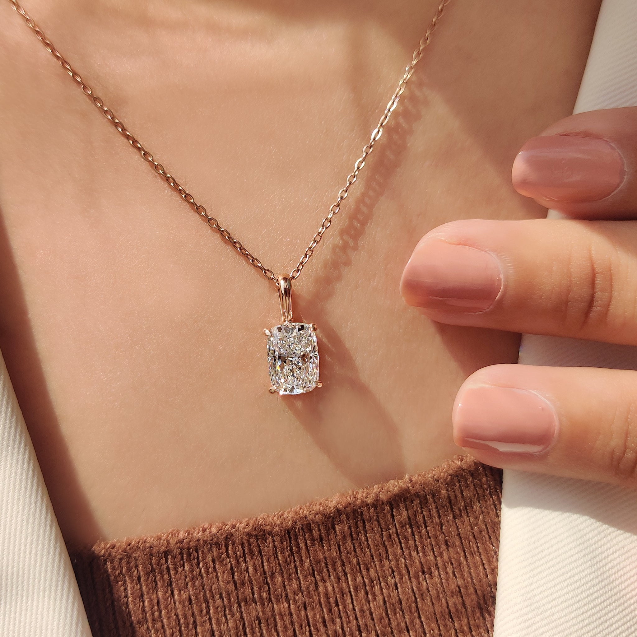 Cushion solitaire pendant with diamond pendant.
