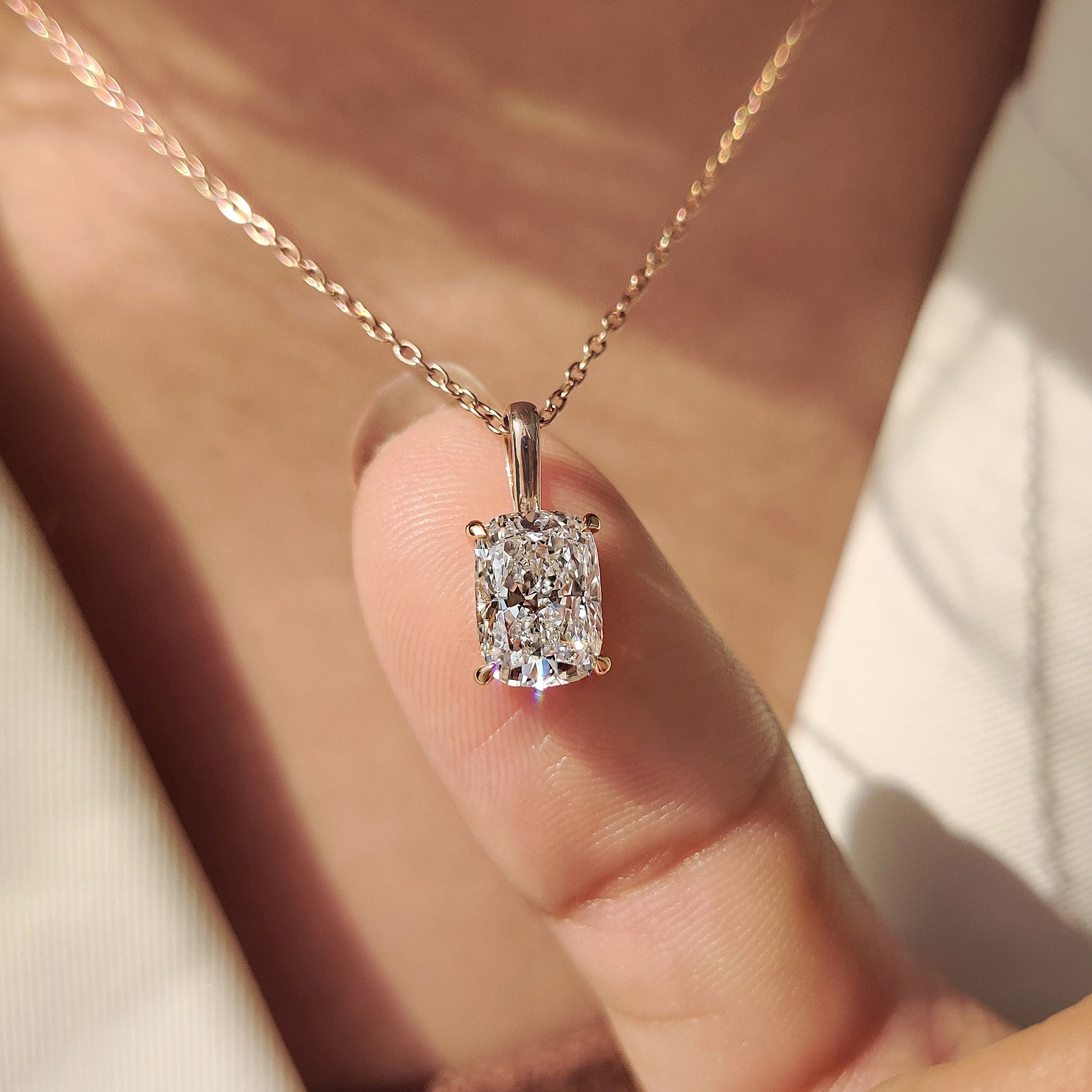 Cushion solitaire pendant in unique diamond pendant.
