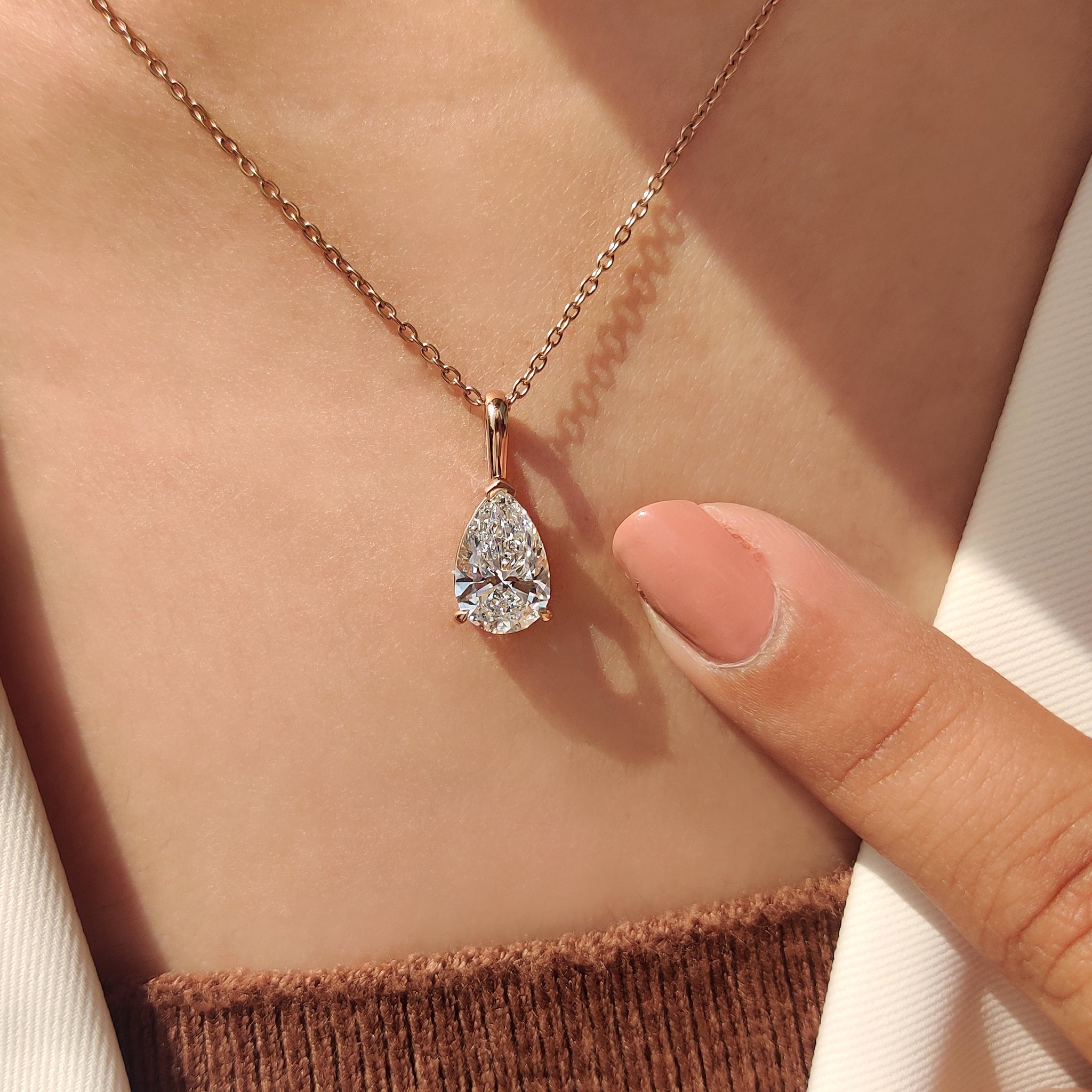 Rose gold pendant with pear cut solitaire pendant.
