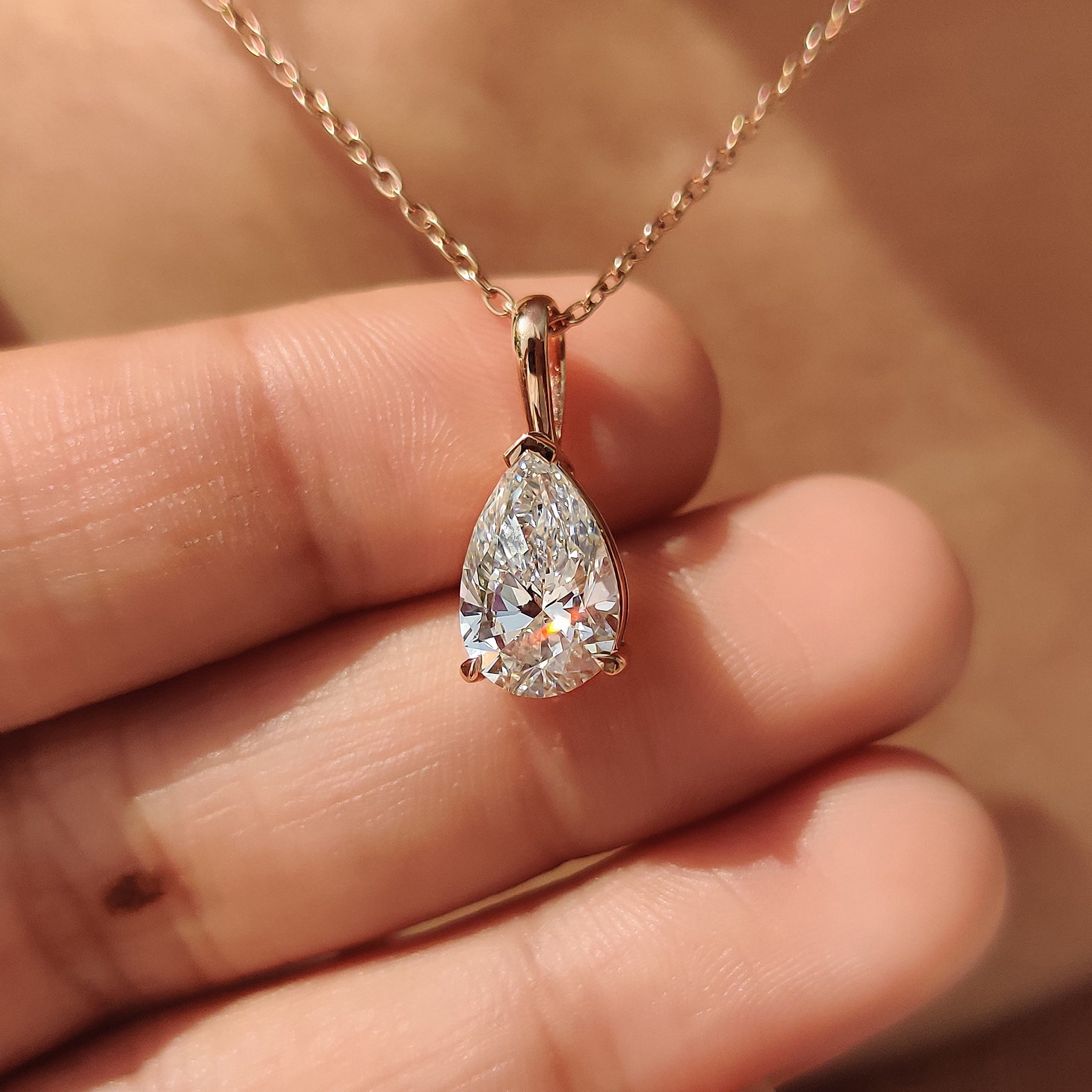 Pear cut solitaire pendant with claw prong setting.
