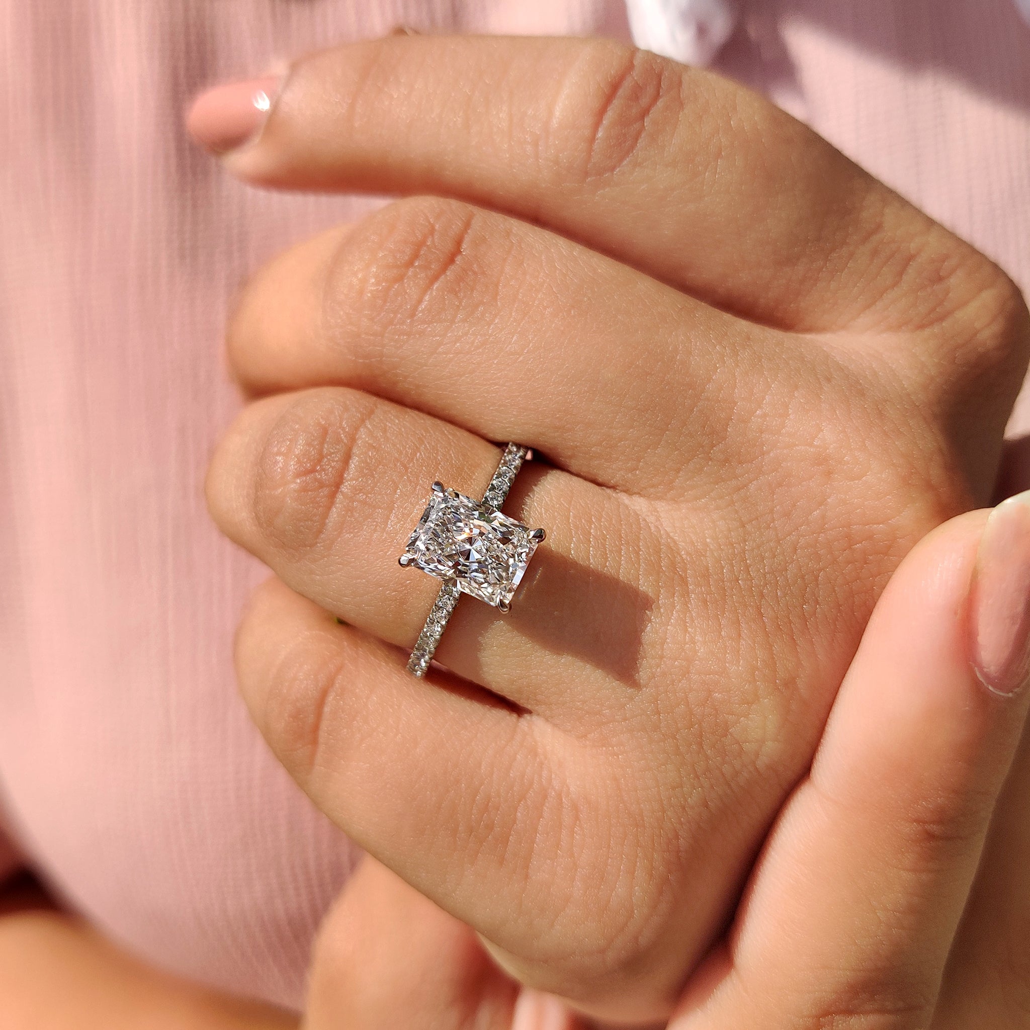 Buy diamond ring with radiant cut center stone.
