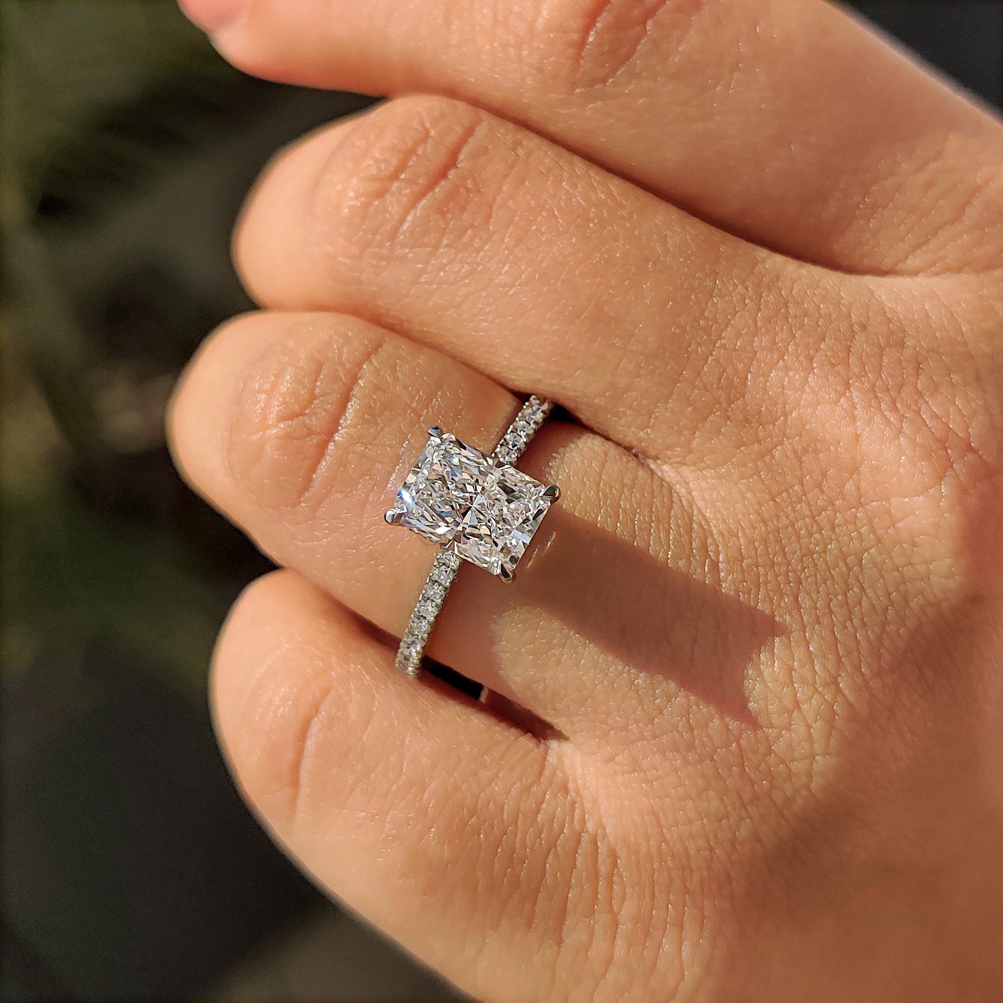 Cathedral setting engagement ring with hidden halo accent.
