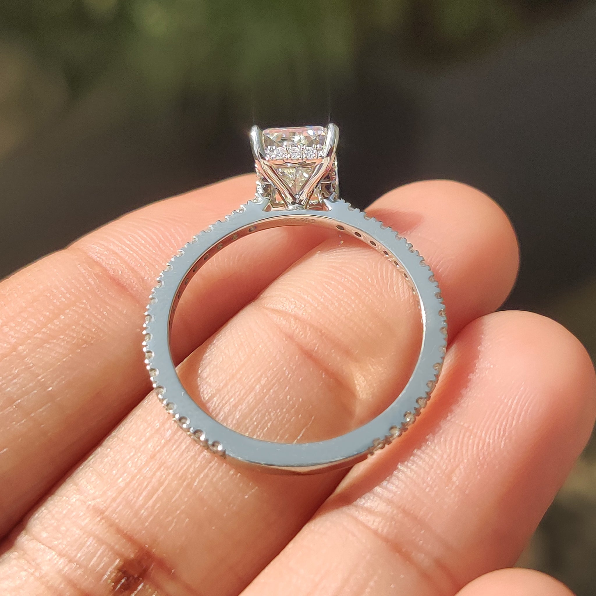 Hidden halo engagement ring with white gold diamond ring look.
