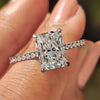 Radiant cut engagement ring with pave setting ring design.
