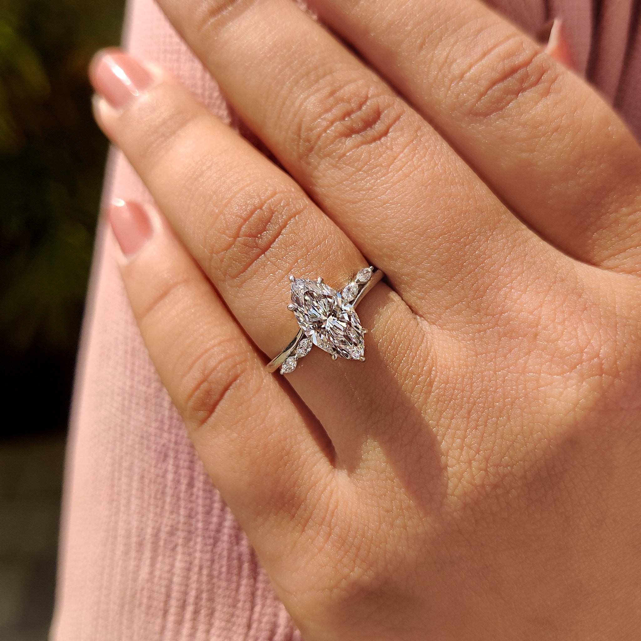 Marquise side stone with hidden halo engagement ring.