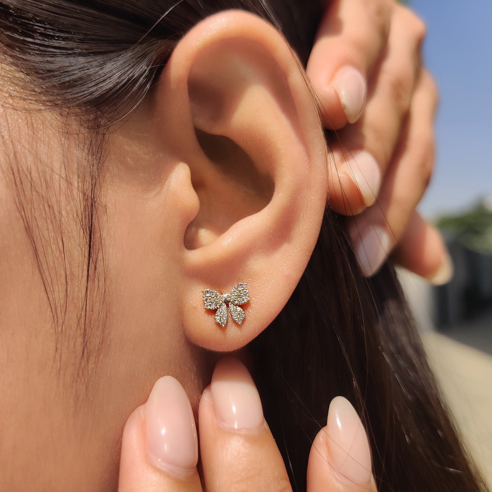Round cut diamond bow stud earrings for everyday wear

