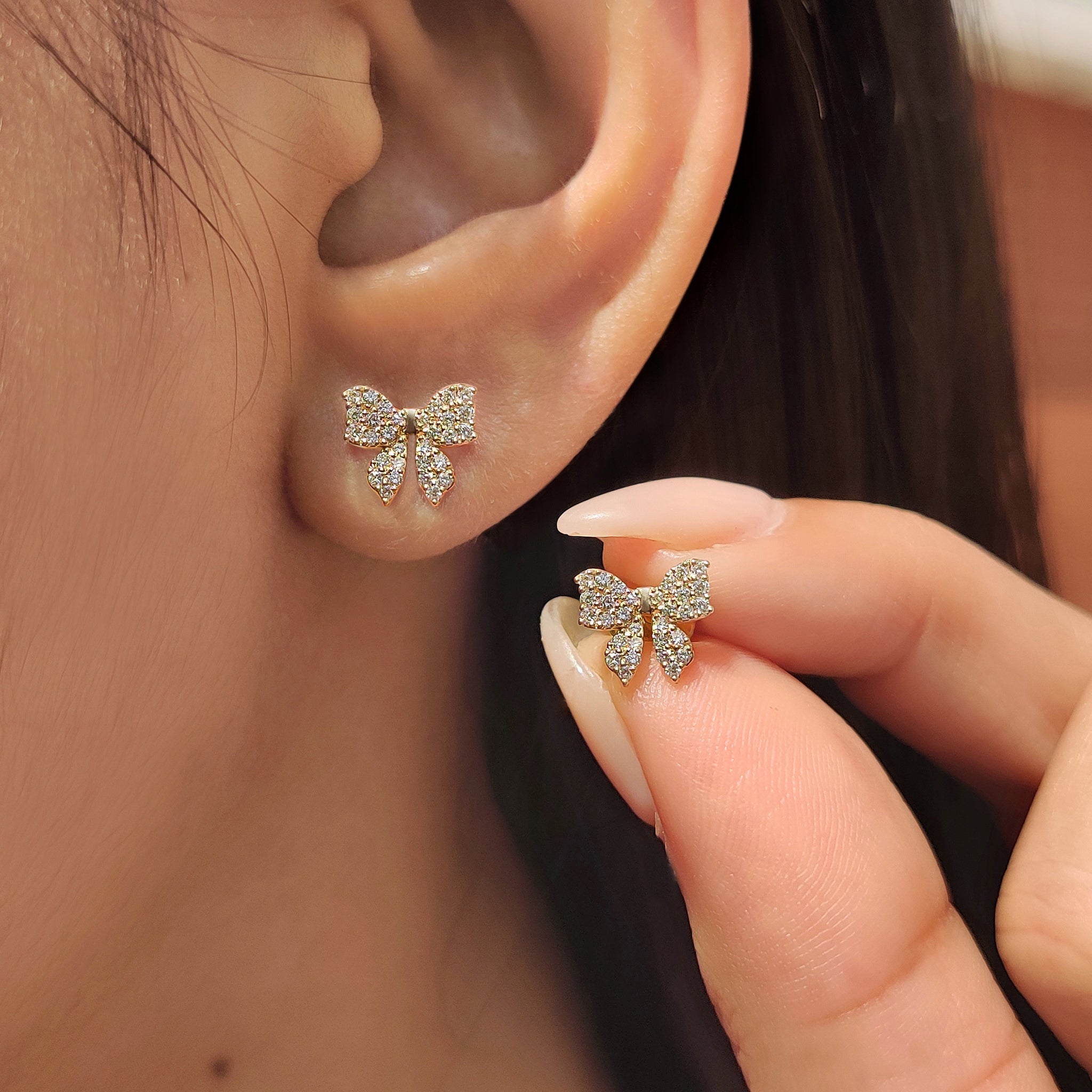 Handmade gold bow earrings with secure screw back design
