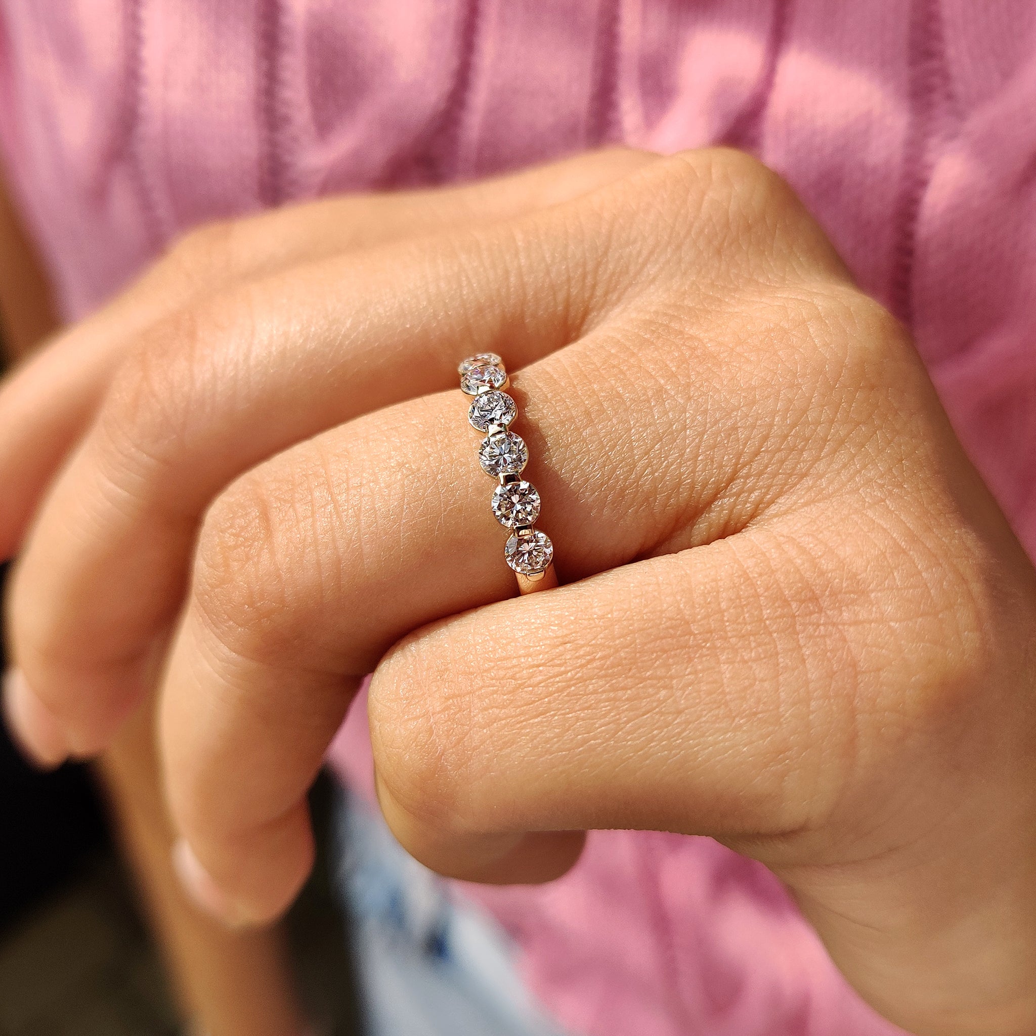 Yellow gold wedding band featuring eight round cut diamonds.
