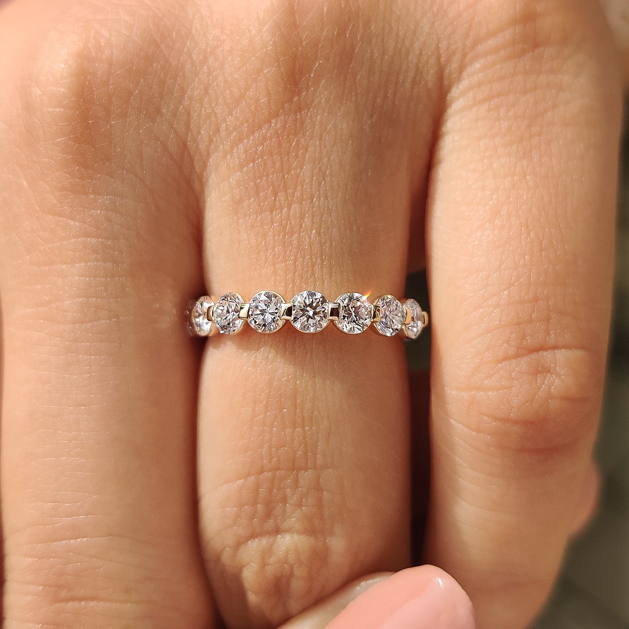 Elegant shared prong wedding band with round lab grown diamonds.

