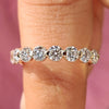 Shared prong half eternity diamond wedding band in yellow gold.
