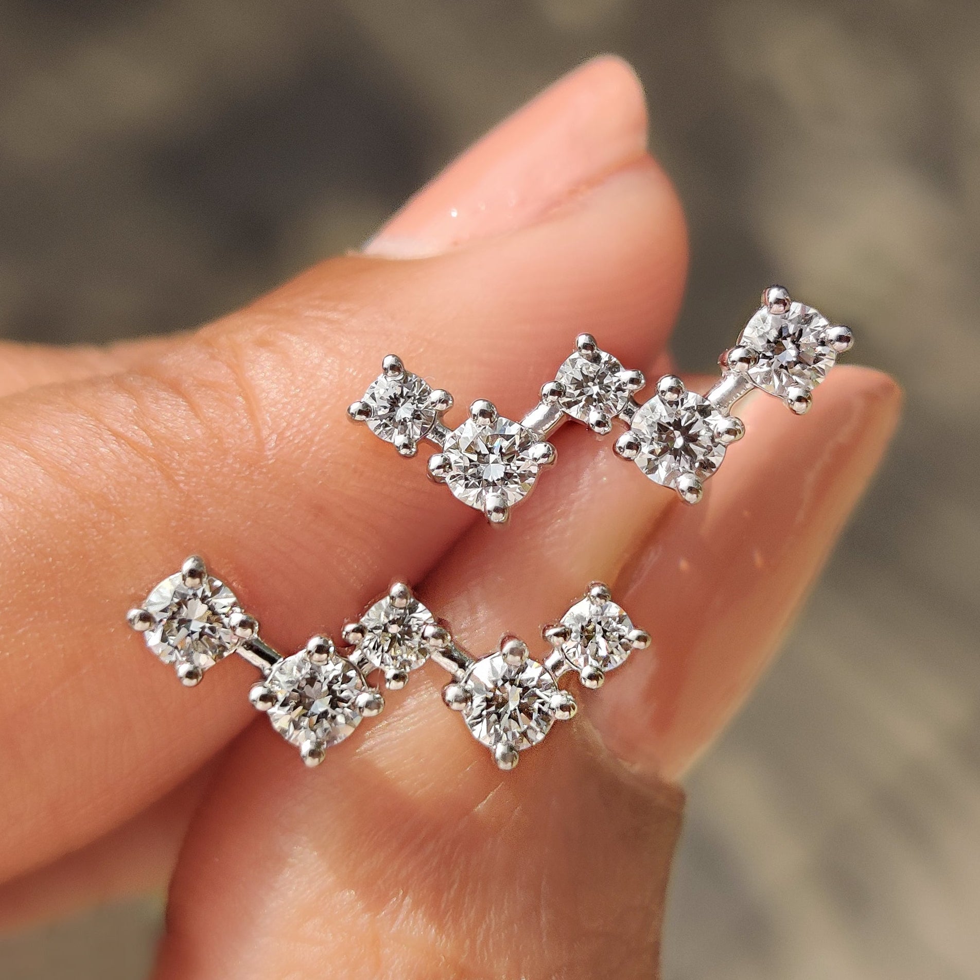Round diamond stud earrings with white gold setting and screw back design
