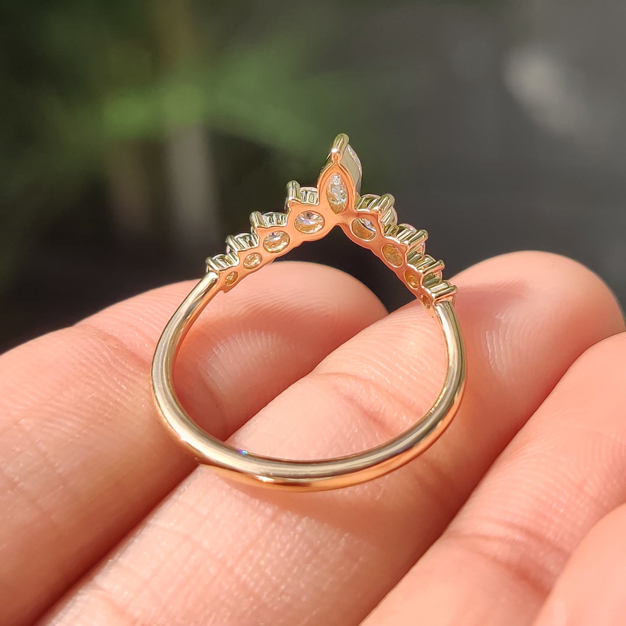 Stackable wedding band featuring marquise and round diamond accents
