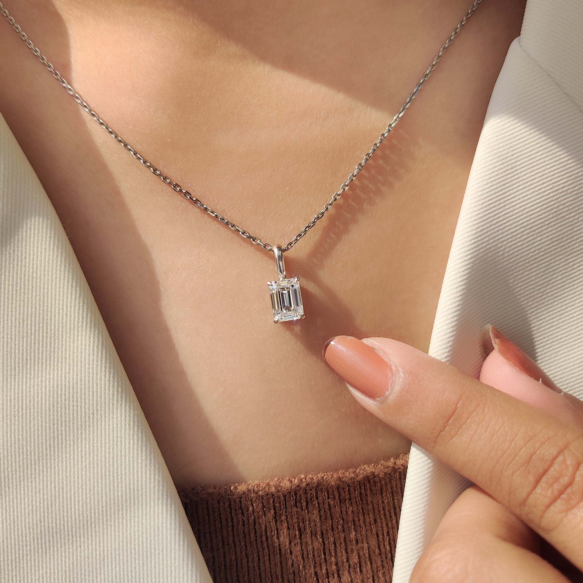White gold pendant featuring emerald cut diamond and handmade jewelry finish
