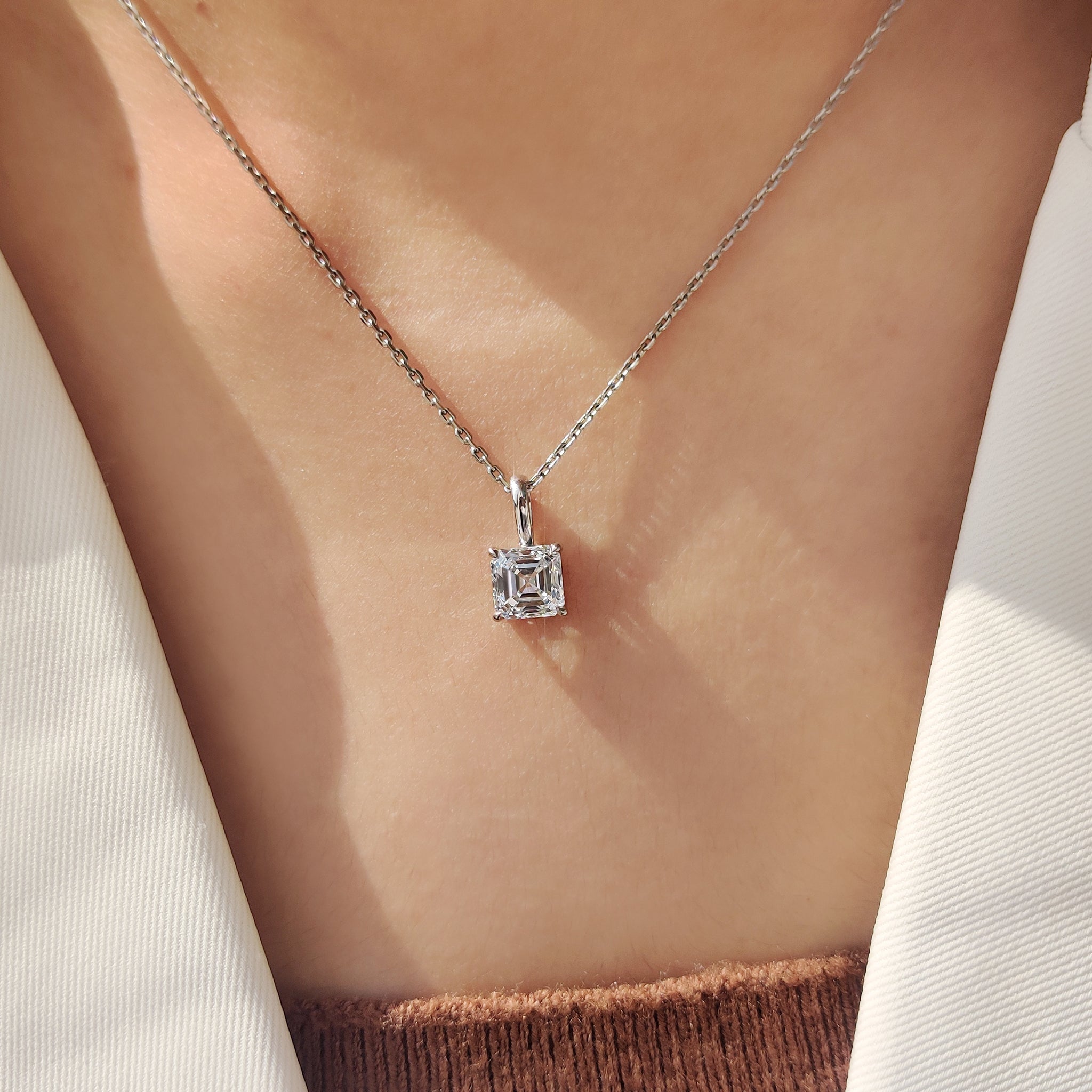 Asscher cut diamond pendant in white gold with four claw prong setting
