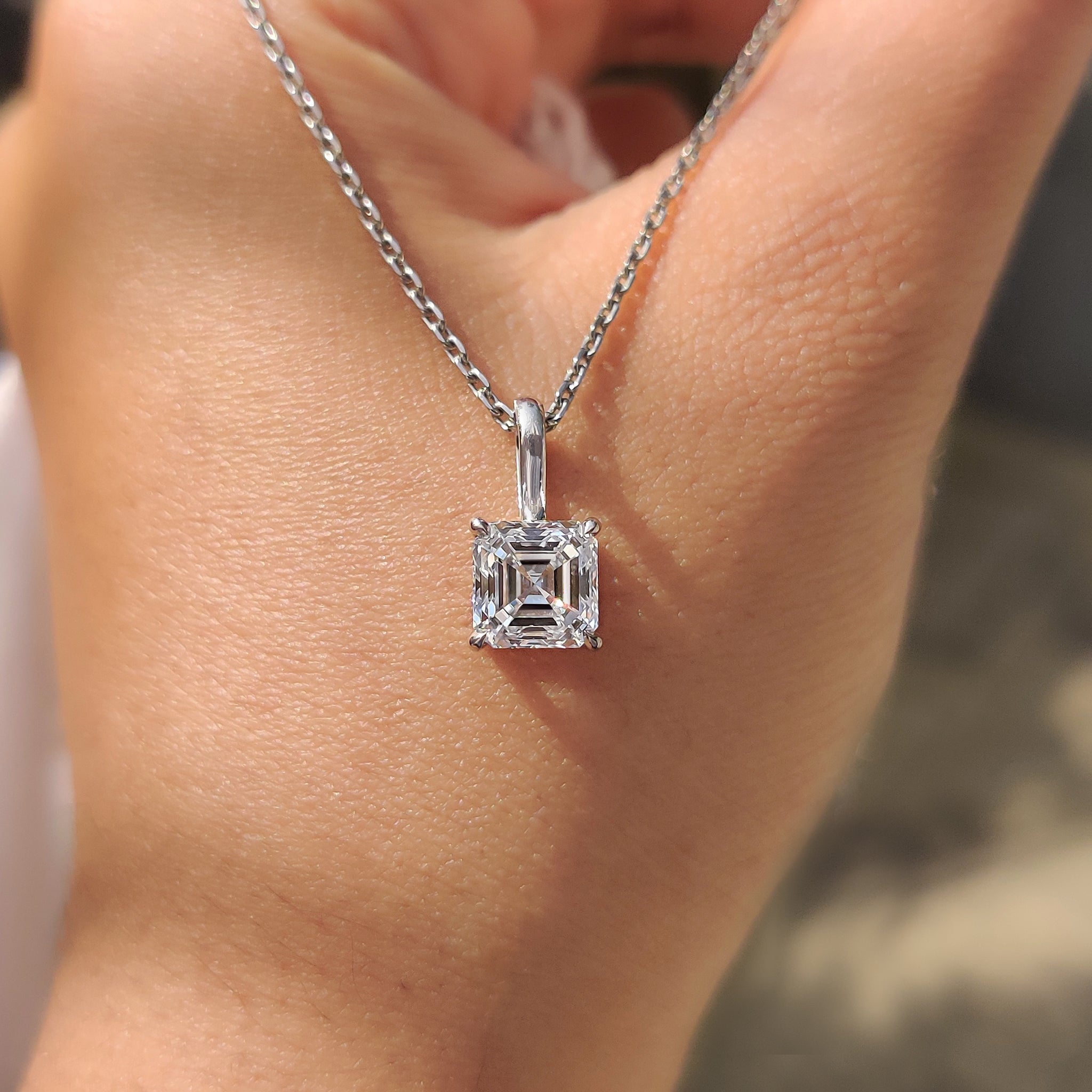 White gold diamond pendant showcasing a single Asscher cut stone
