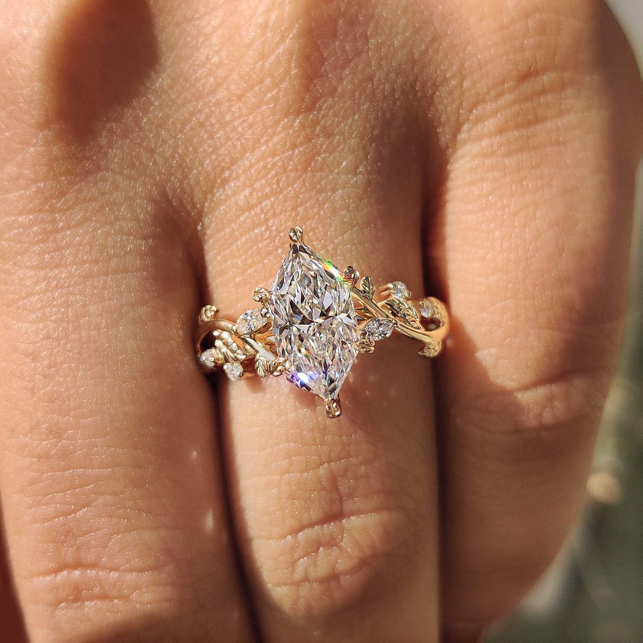 Marquise and round side stone with cluster setting ring.