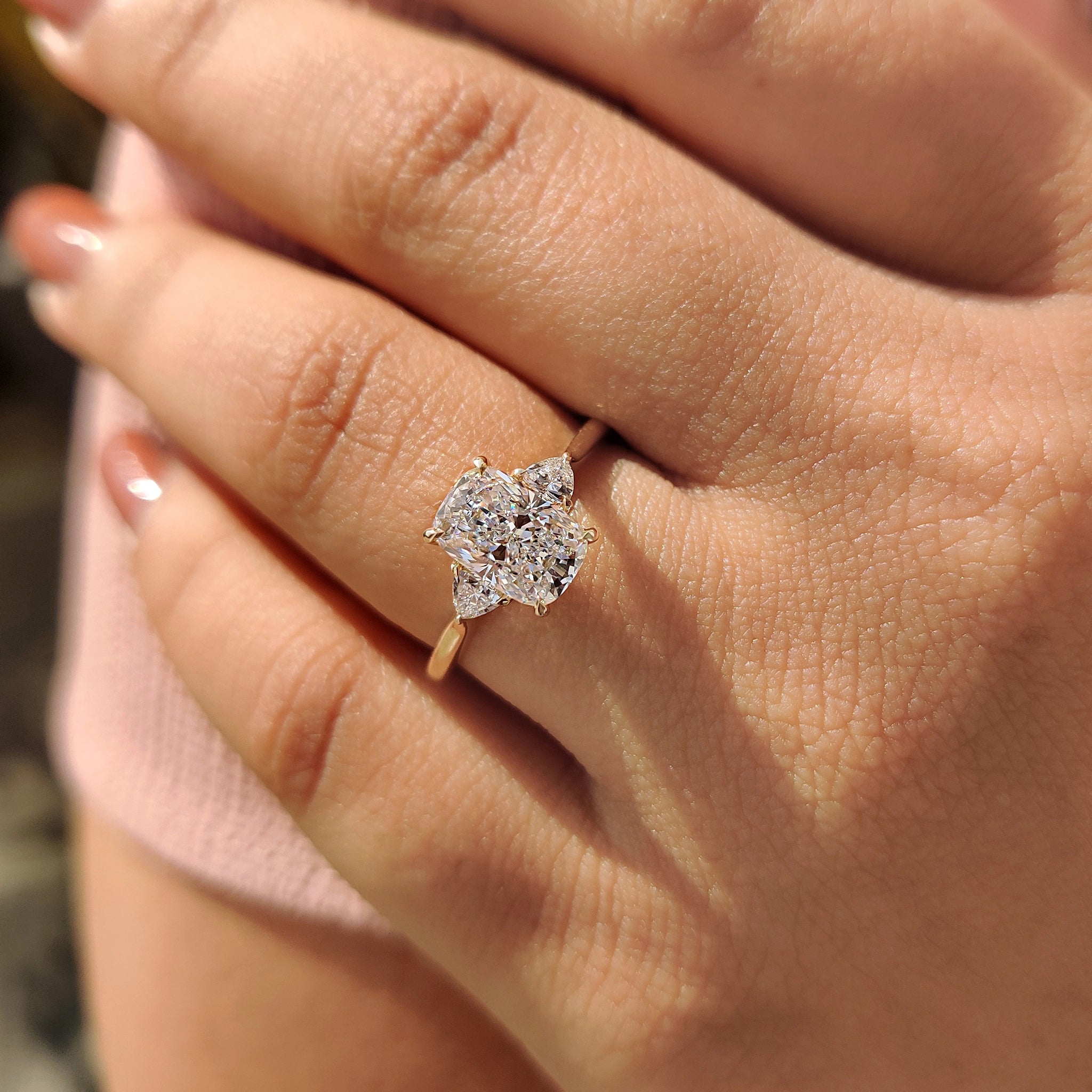 Carat diamonds engagement ring with two trillion side stones and cathedral setting.
