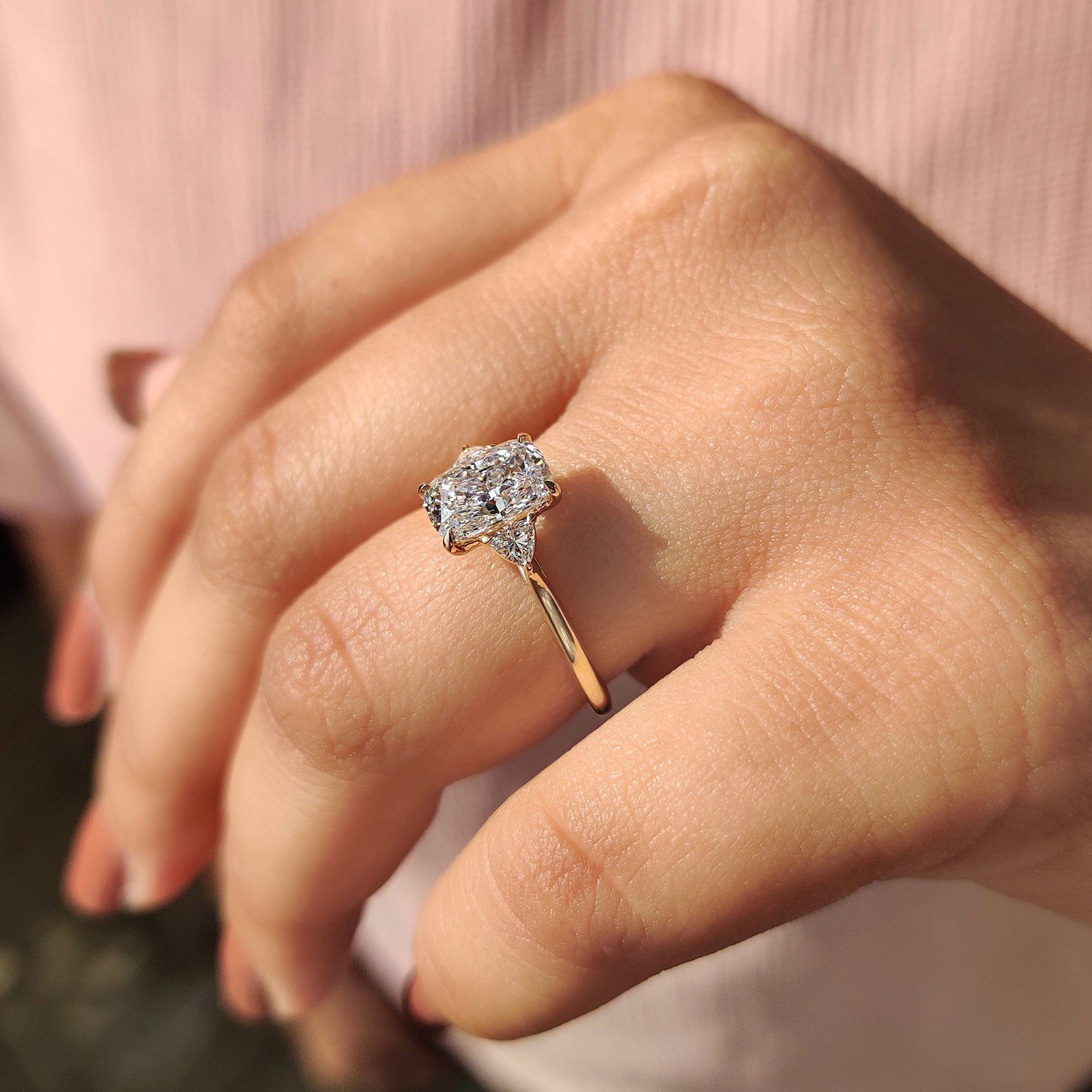 Buy diamond ring with elongated cushion cut and yellow gold band.
