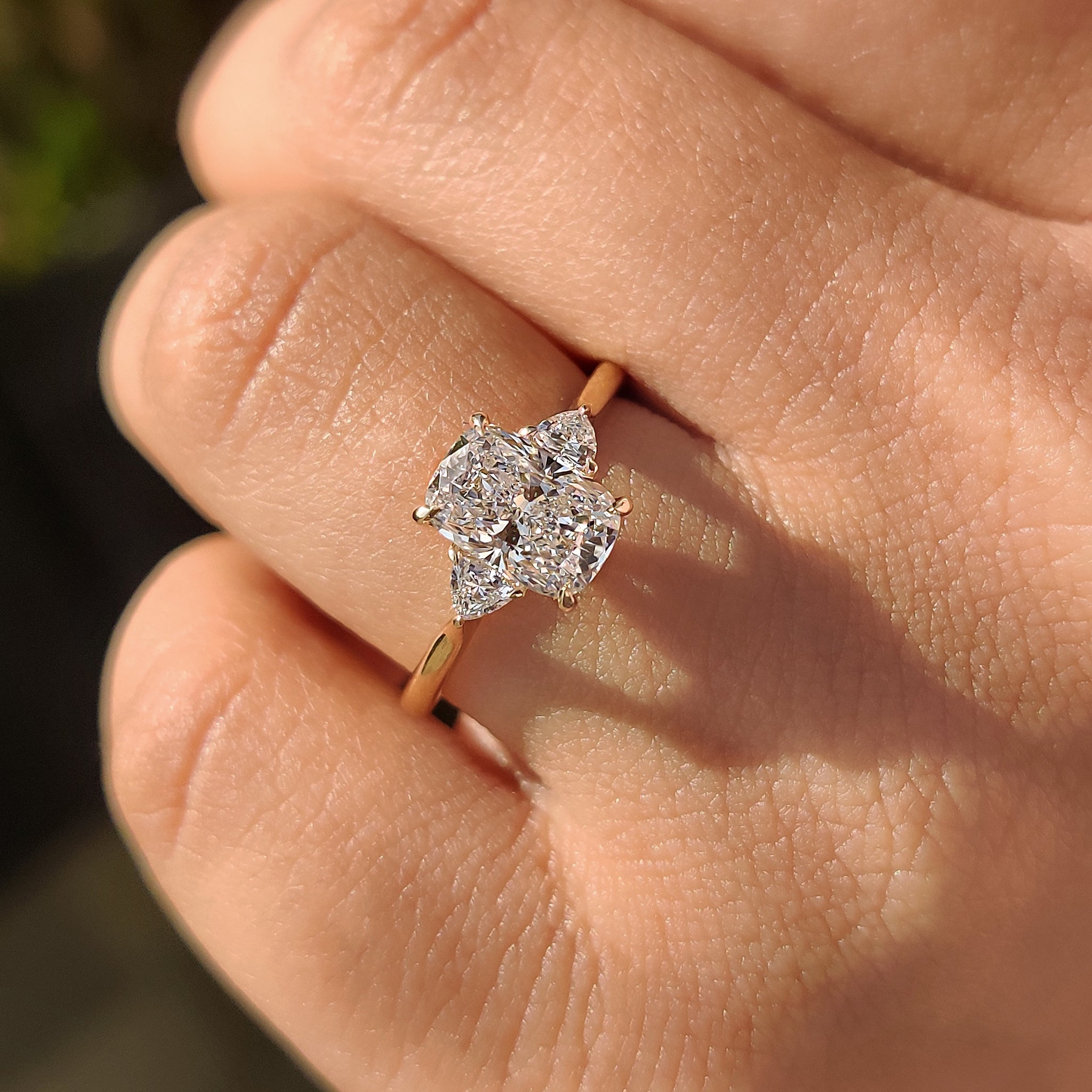 IGI certified diamond engagement ring with three stone design in yellow gold.
