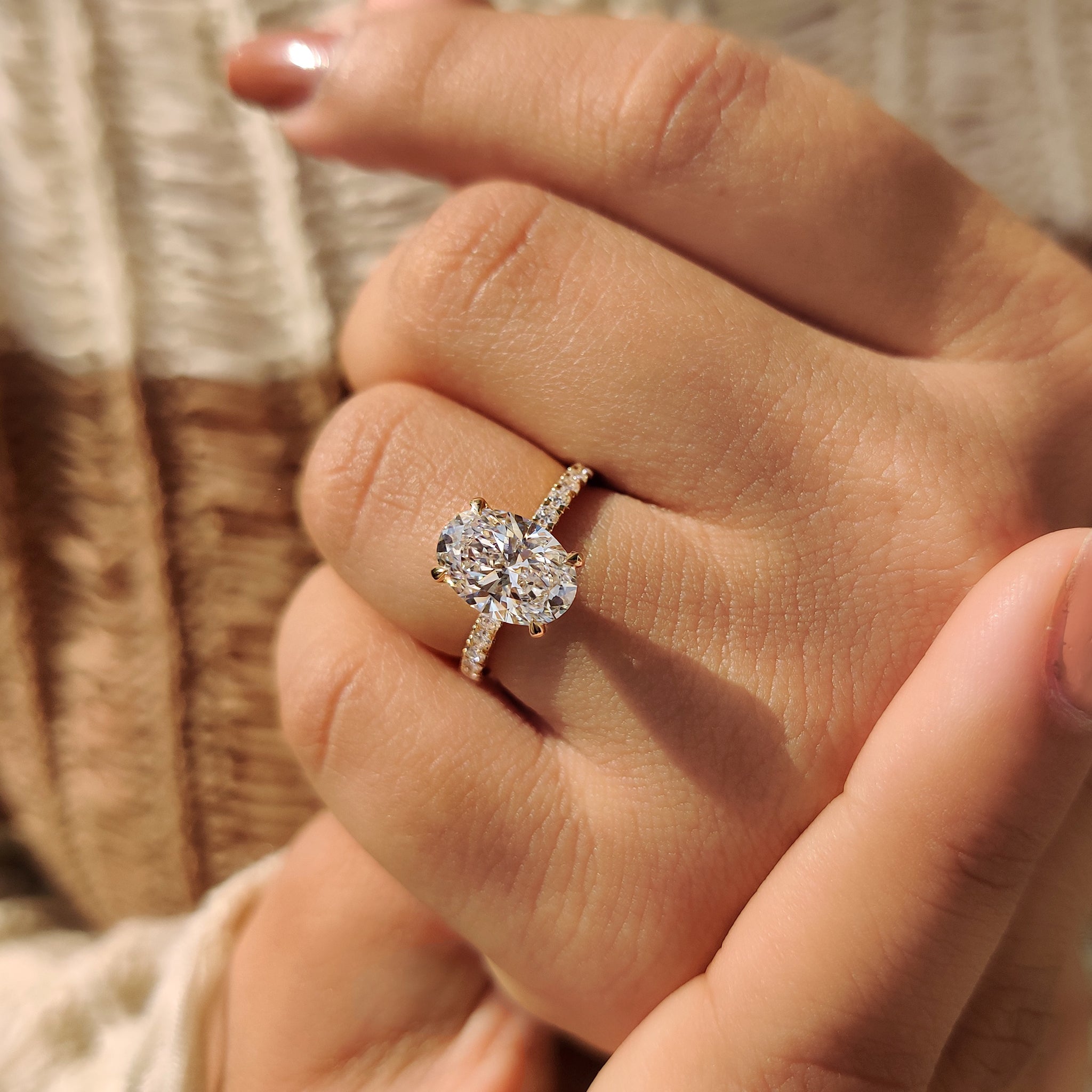 Custom engagement ring with yellow gold band and round cut diamond hidden halo.