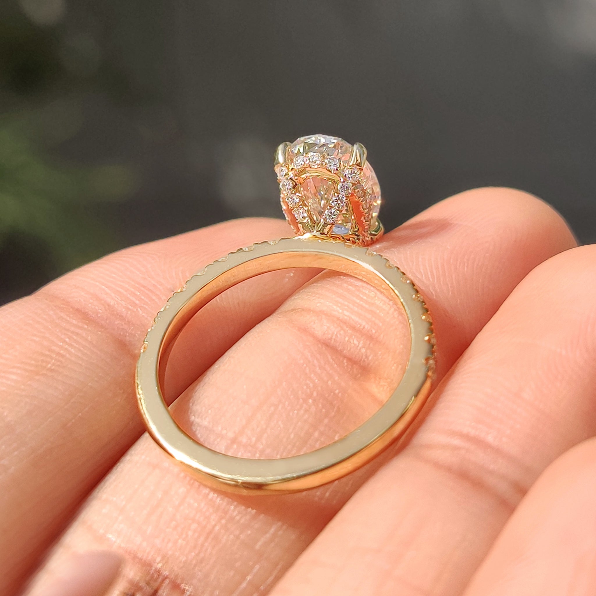 Carat diamonds engagement ring with hidden halo and four claw prong oval diamond.