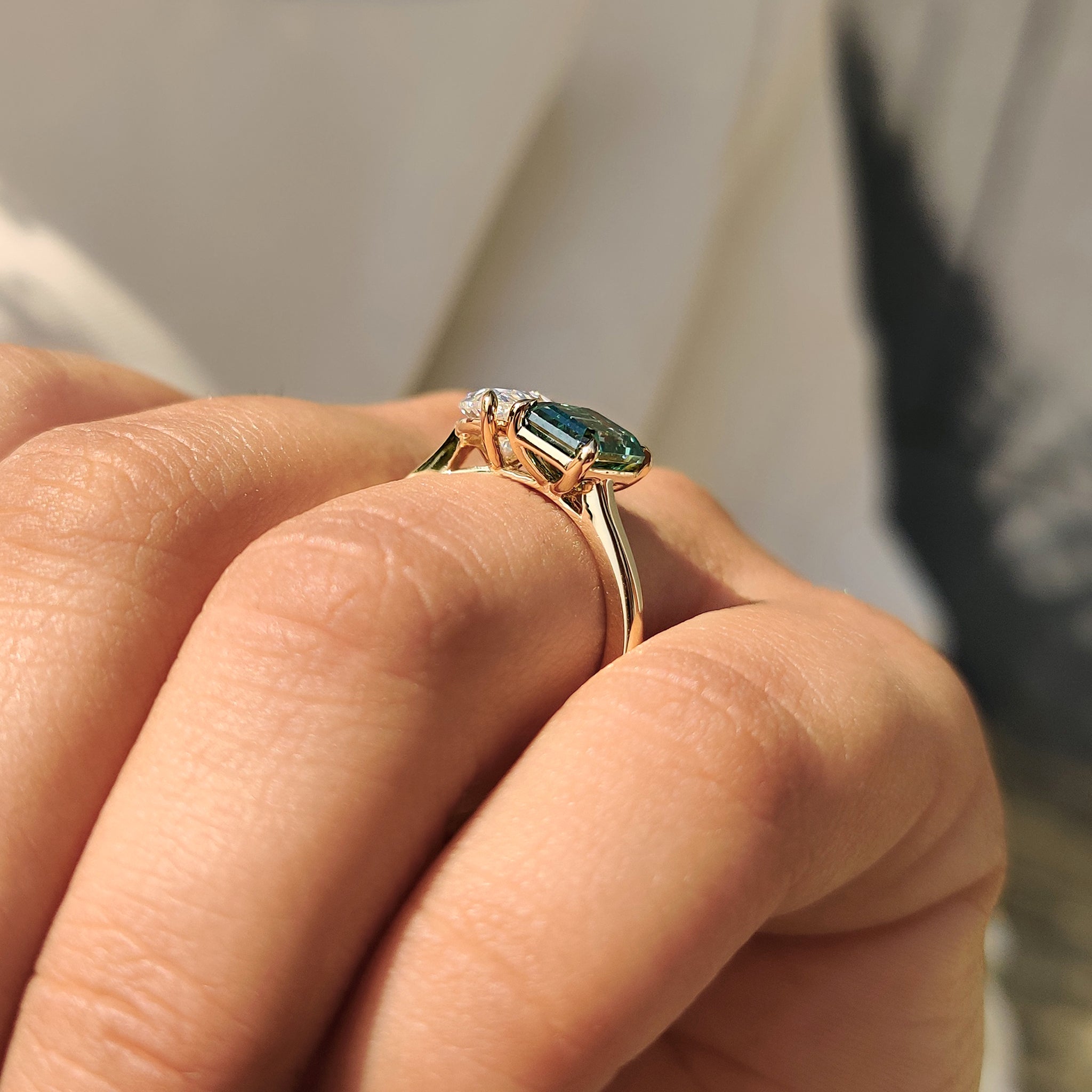 Carat diamonds ring with Toi Et Moi style and green emerald cut stone.