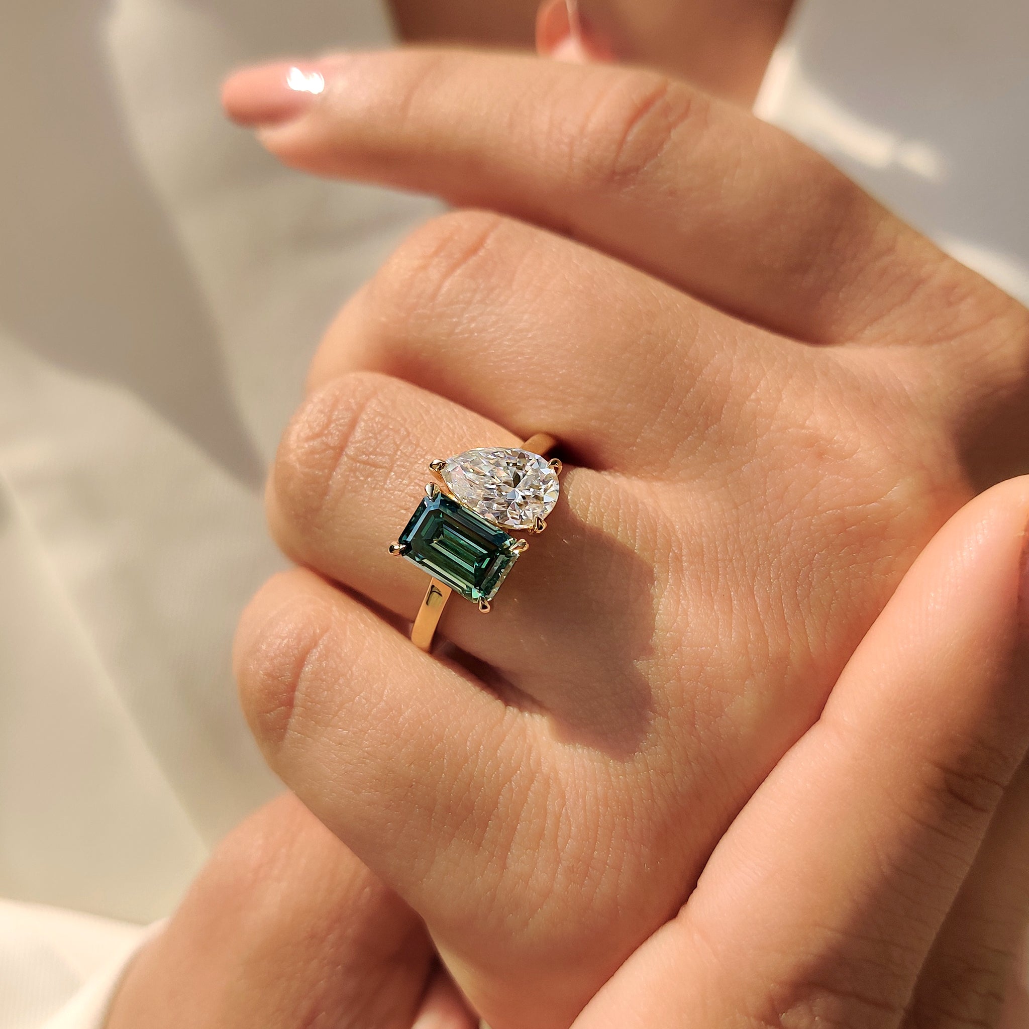 Handmade jewelry yellow gold engagement ring with pear and emerald cuts.