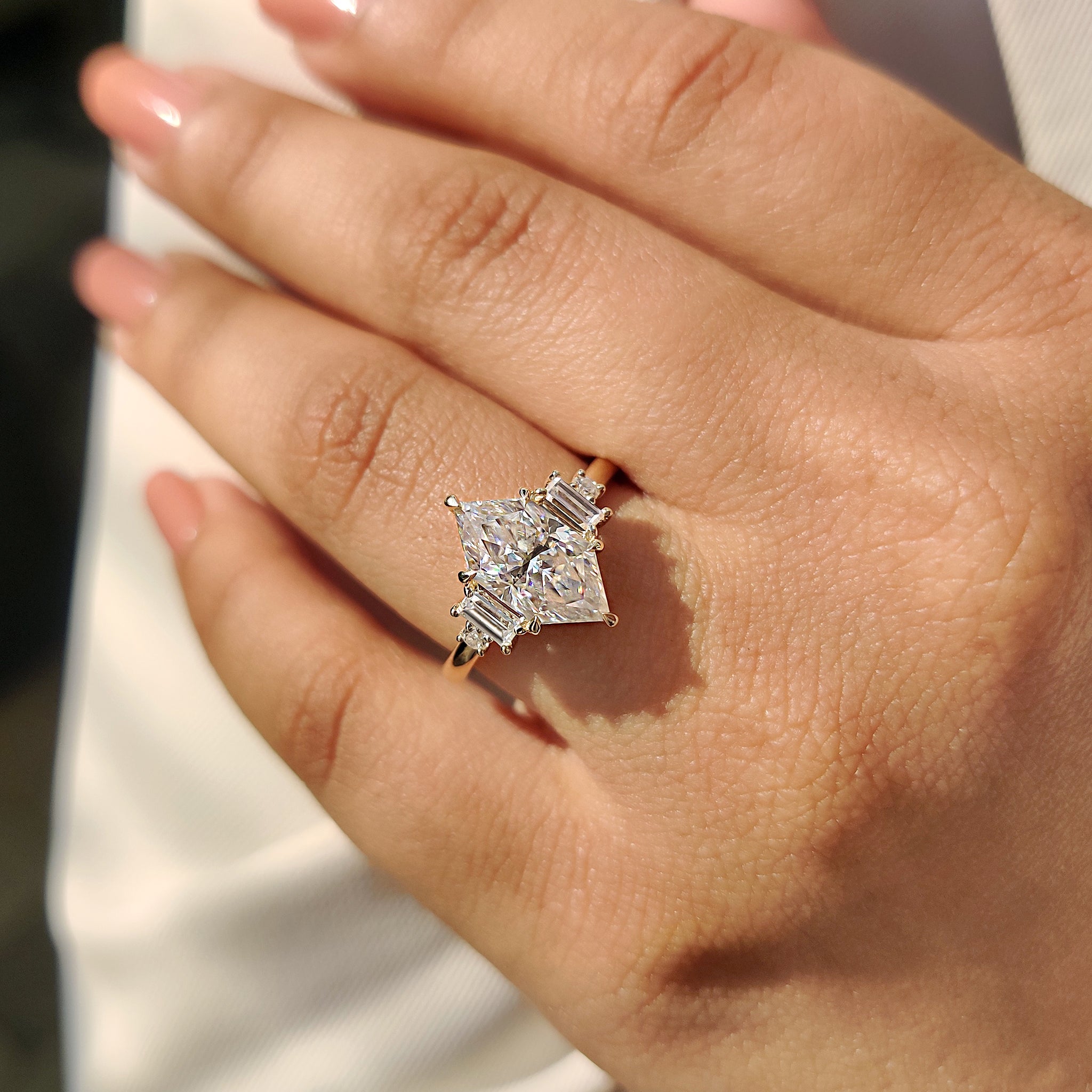 Yellow gold engagement ring with Dutch Marquise cut moissanite and handmade design.
