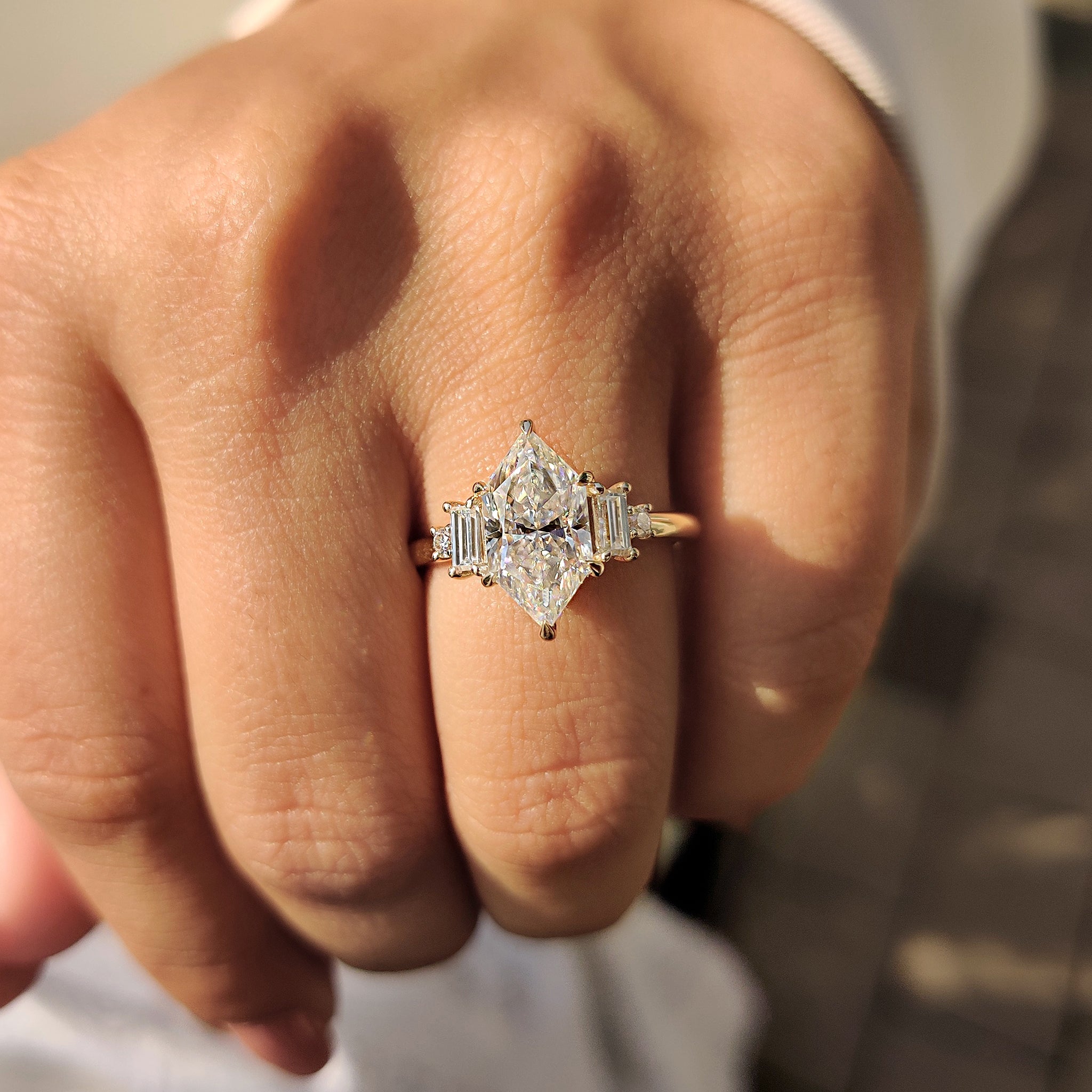 Custom engagement ring with five stone moissanite and six claw prong setting.
