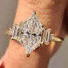 Dutch Marquise moissanite ring in yellow gold with five stone design and six claw prong setting.
