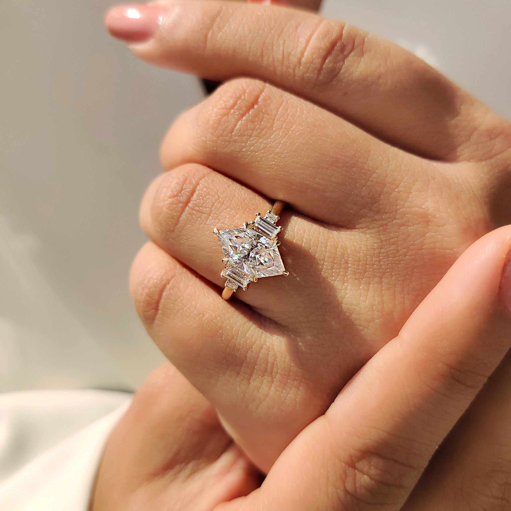 Moissanite engagement ring with five stone design and muse style setting.
