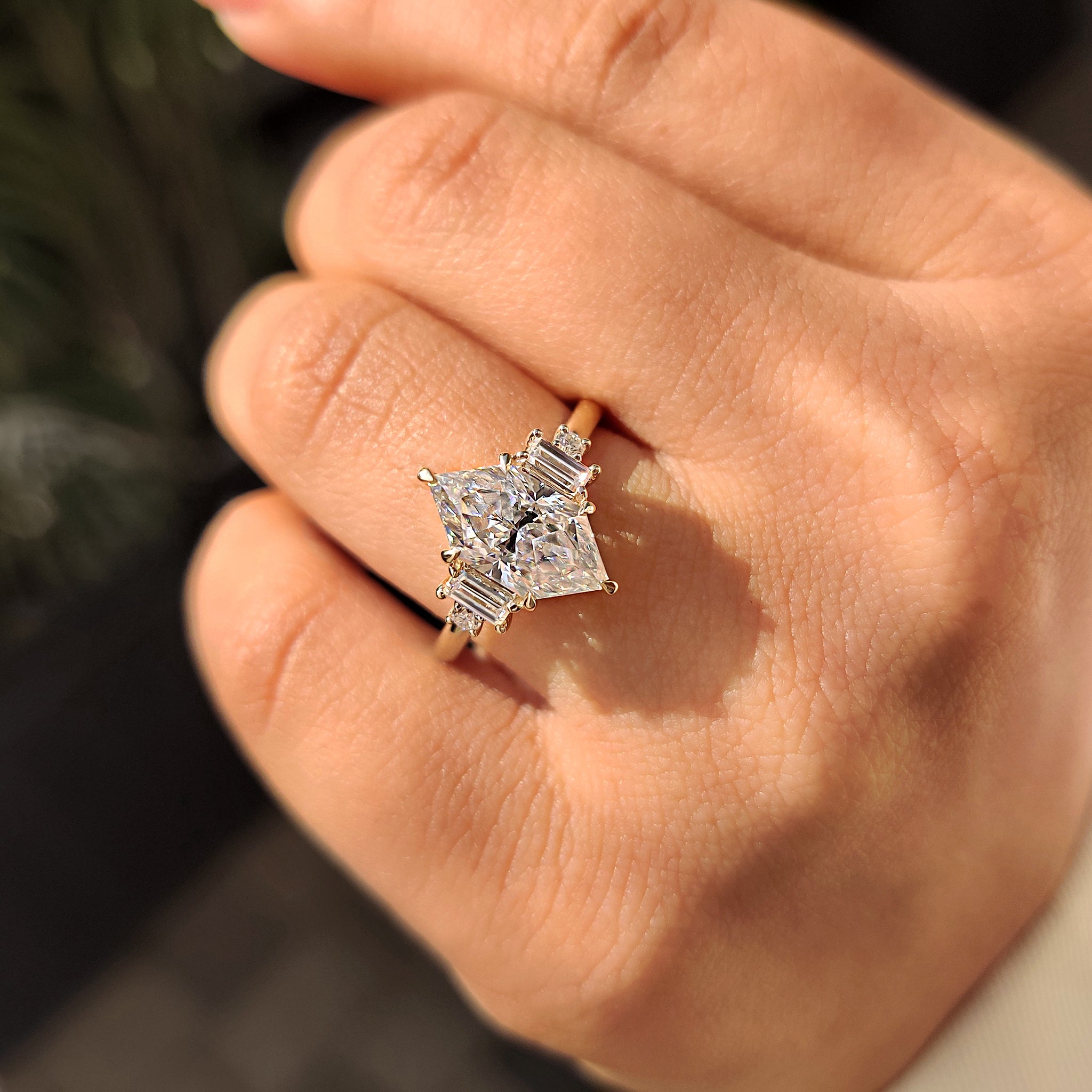 Custom yellow gold ring with Dutch Marquise cut moissanite and handmade details.
