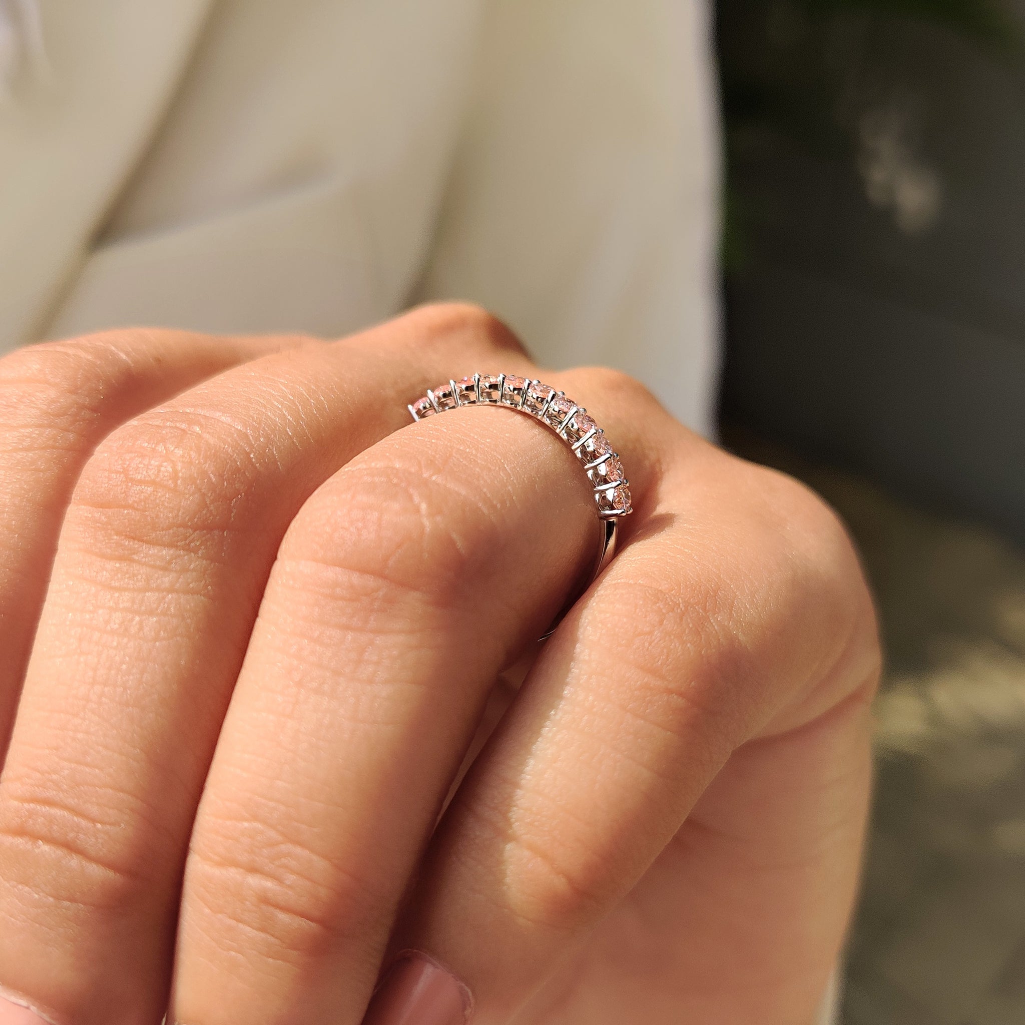 Handmade jewelry wedding band with pink diamond and white gold half eternity style.