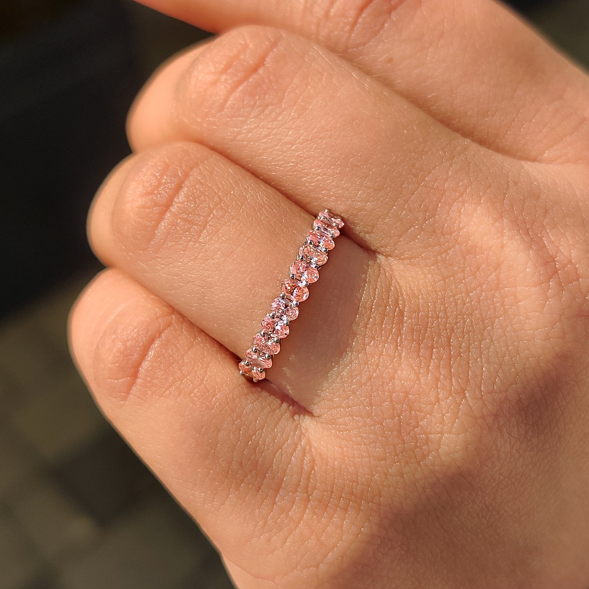 Carat diamonds wedding band with pink diamond and half eternity style.