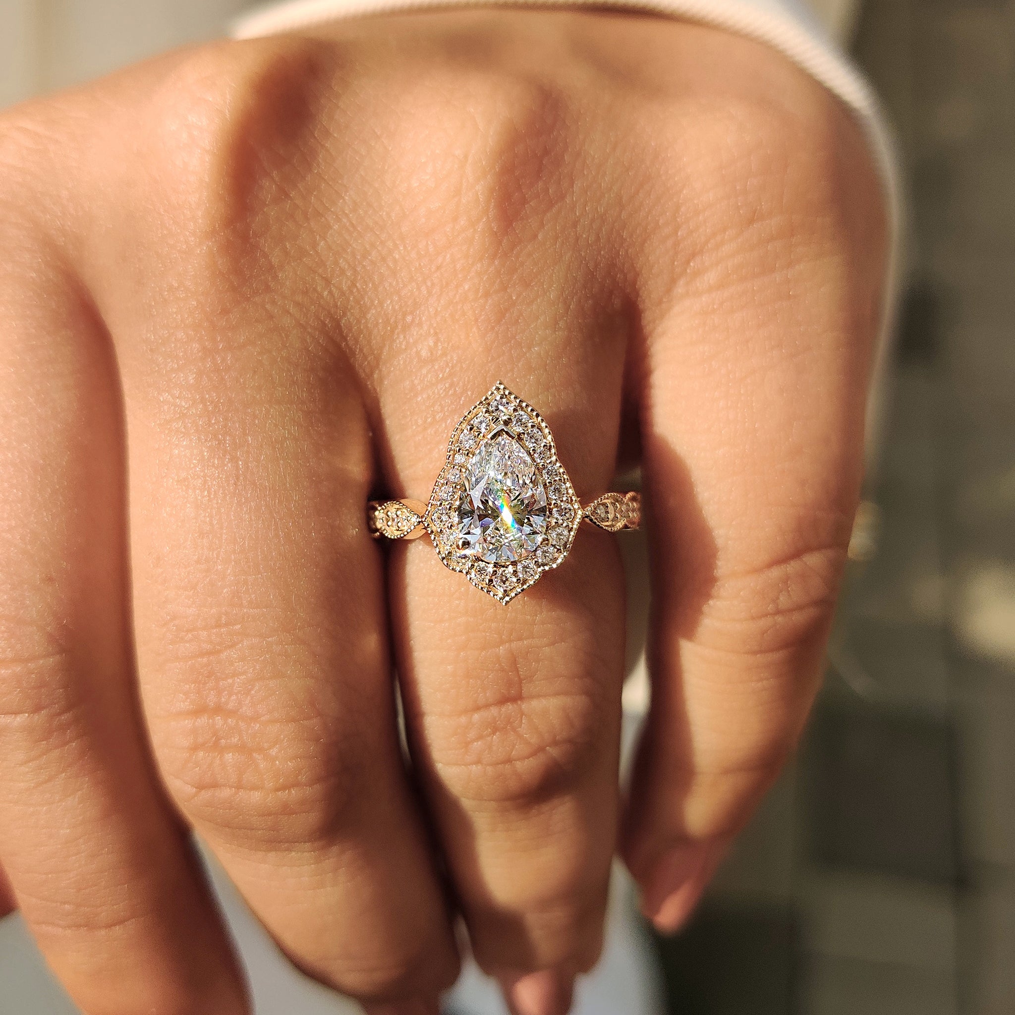 Handmade ring with pear halo and round cut diamond halo in yellow gold.