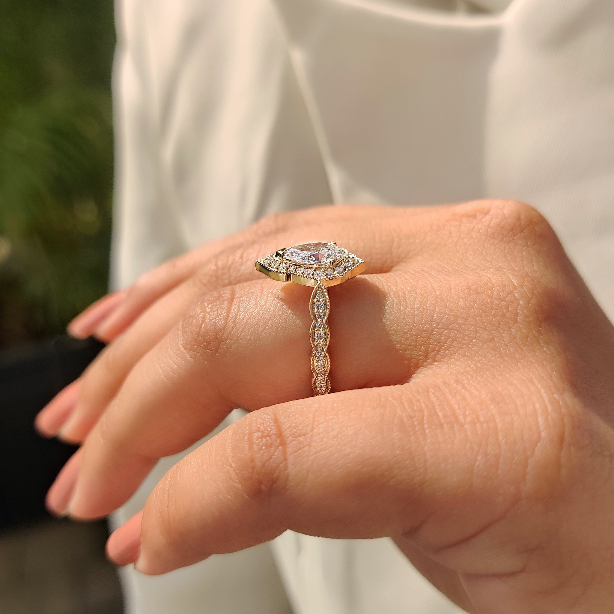 Buy diamond ring with pear cut center and vintage yellow gold design.