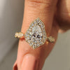 Vintage diamond engagement ring in yellow gold with pear cut diamond and pear halo setting.