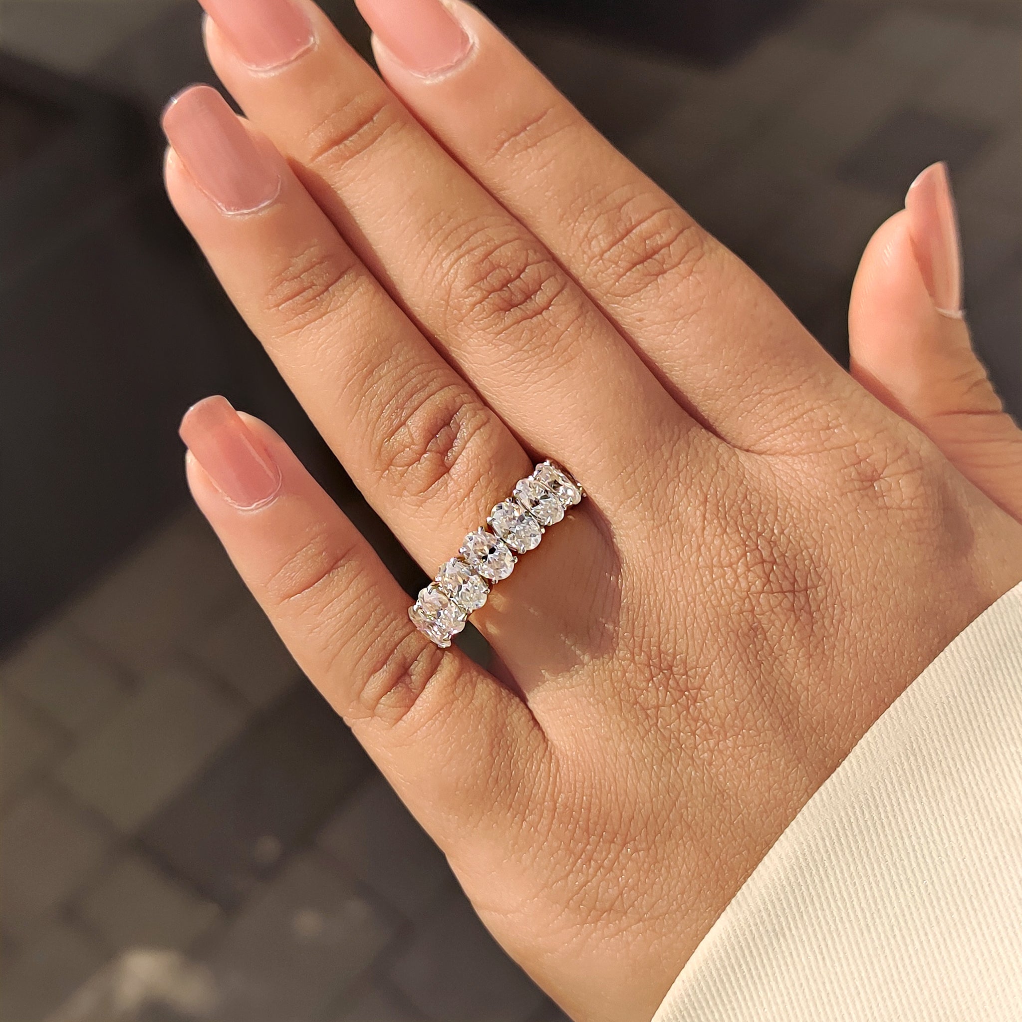 Custom Moissanite wedding band with eight stones and half eternity design.
