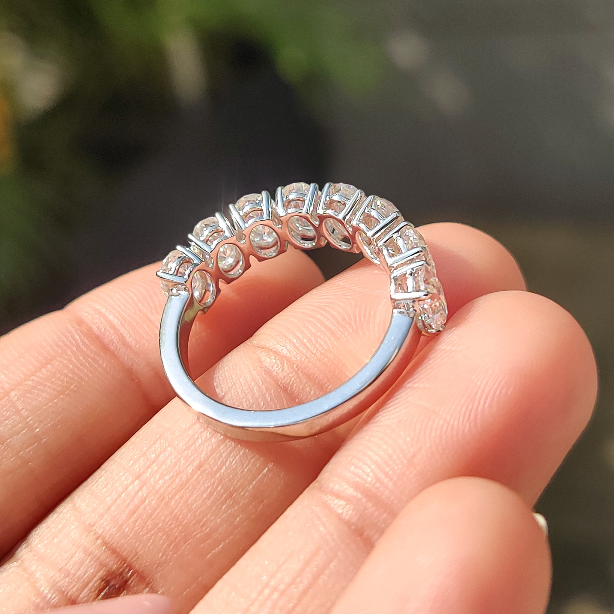 Oval cut Moissanite wedding band in white gold with handmade jewelry craftsmanship.
