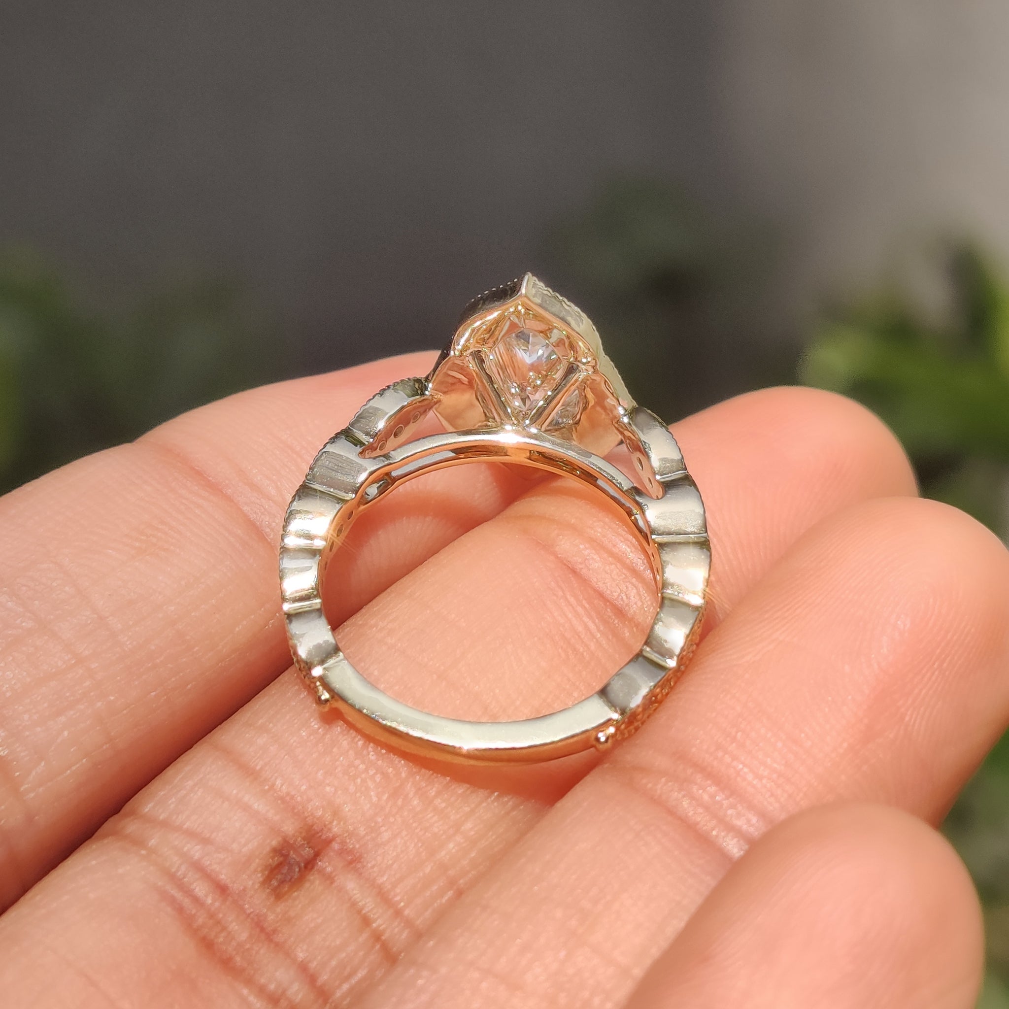 Handmade jewelry engagement ring with pear cut center and gold halo.
