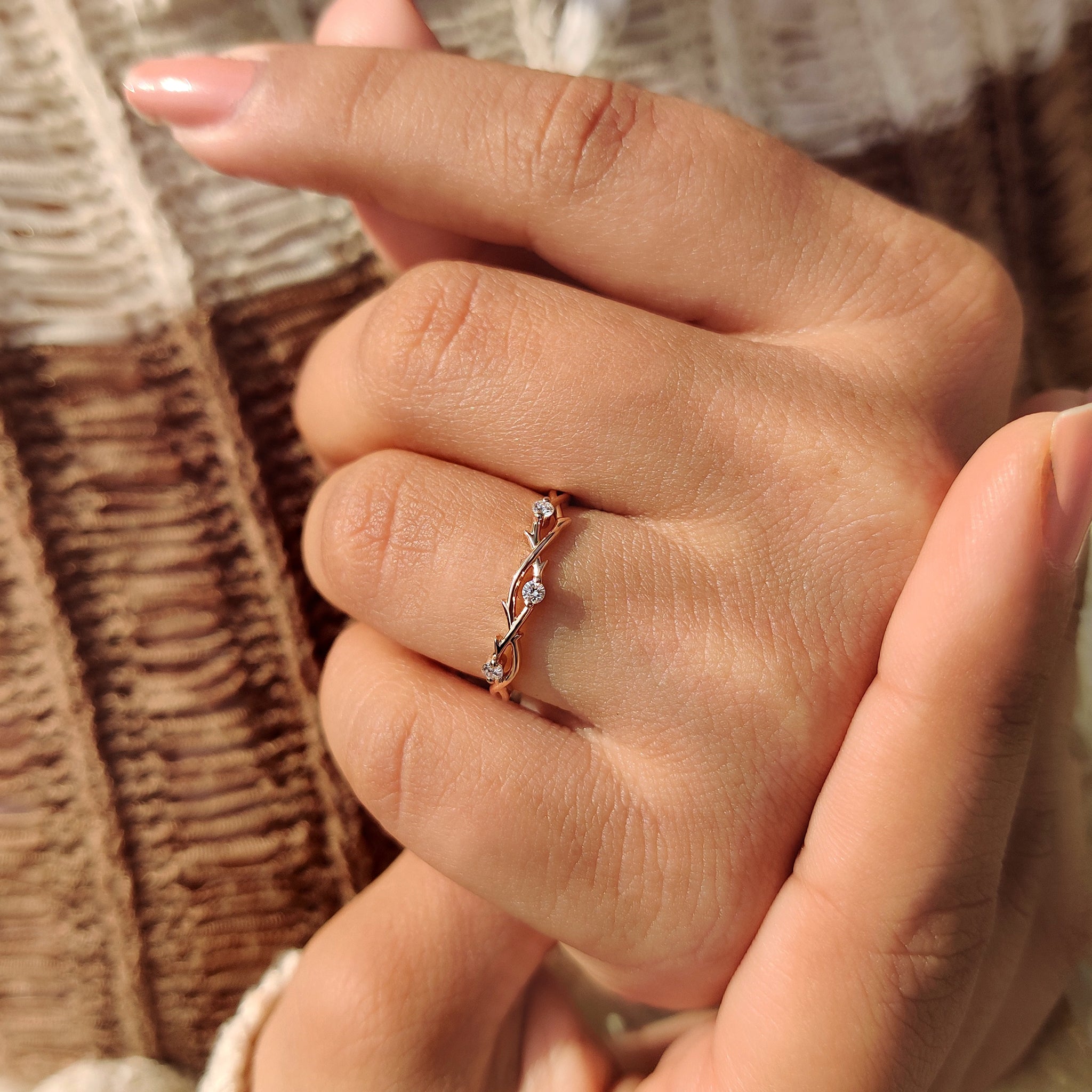 Handmade band with three stone design in rose gold and nature inspired style.
