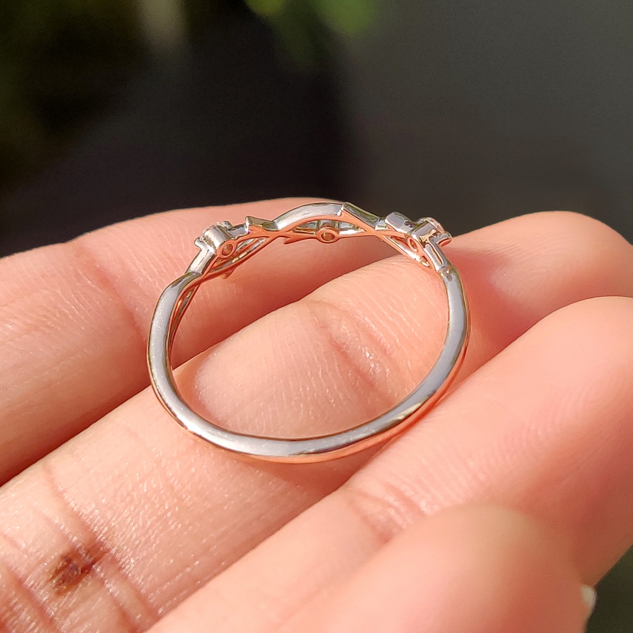 Lab grown diamond wedding band in rose gold with minimalist three stone style.
