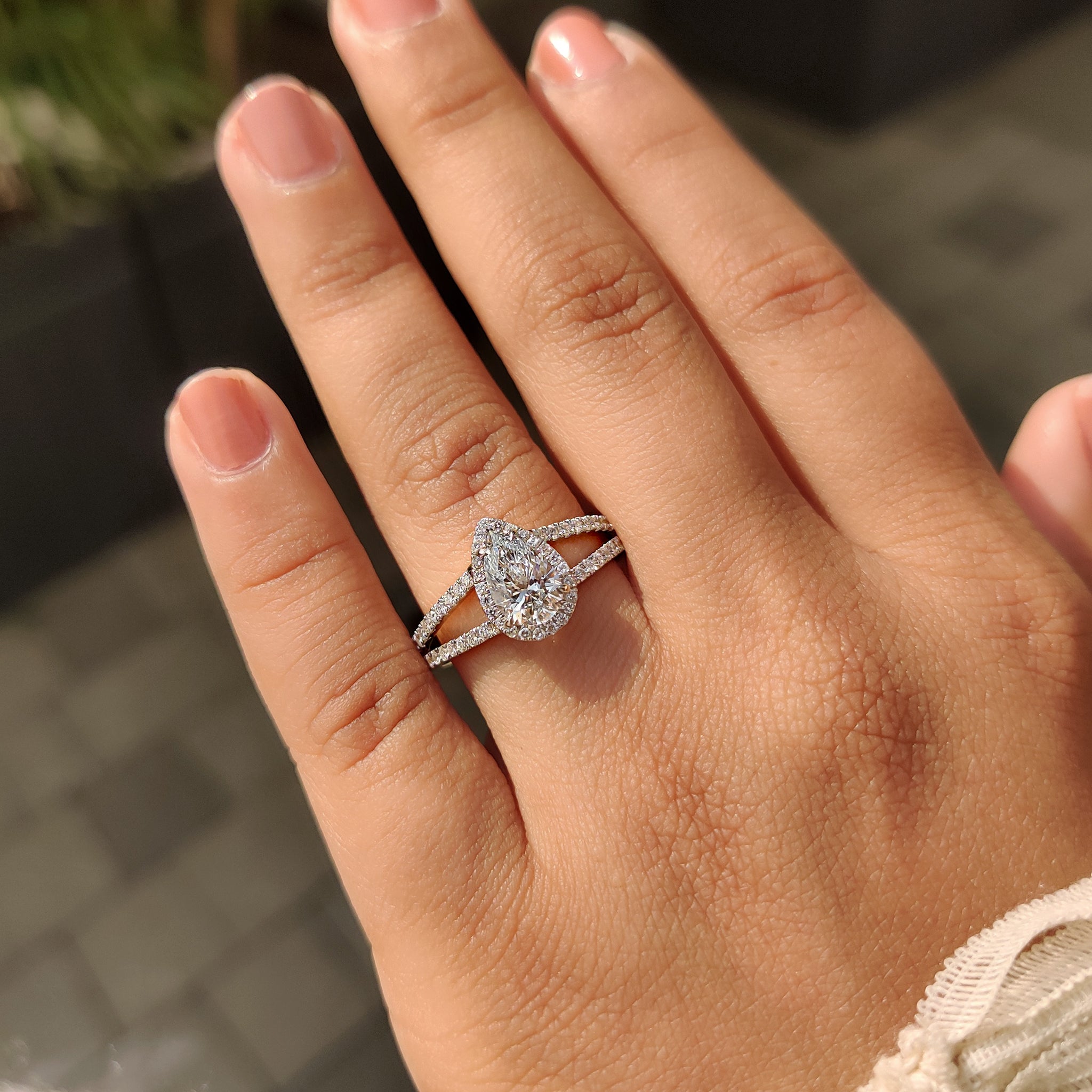 Carat diamonds engagement ring with split shank and four claw prong pear diamond.