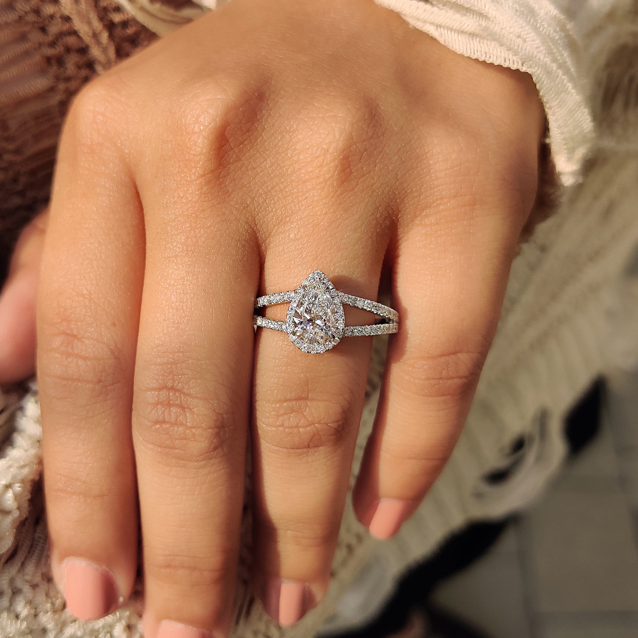 Buy diamond ring with pear cut center and round cut side stones.