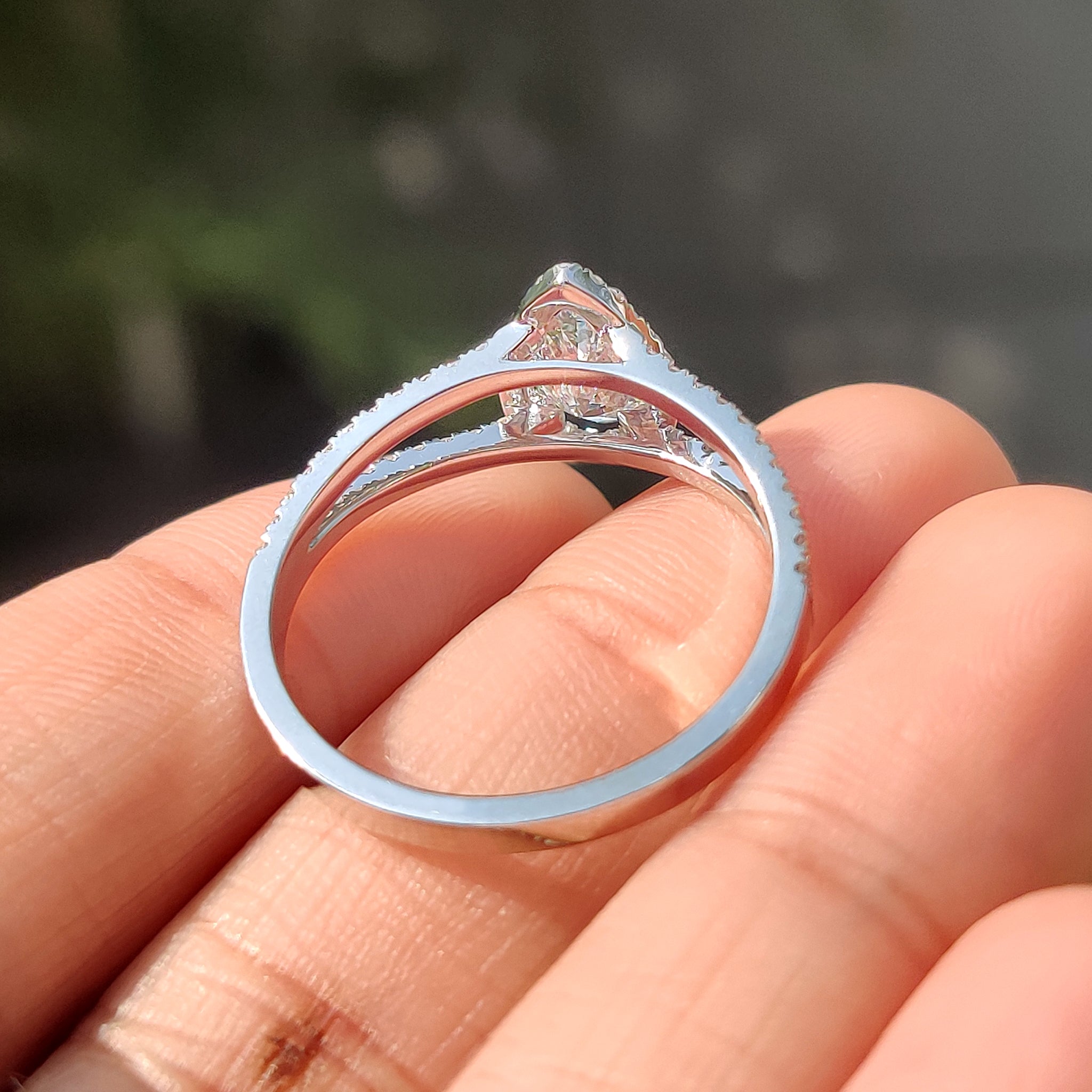 White gold pear cut diamond ring with split shank and handmade jewelry design.