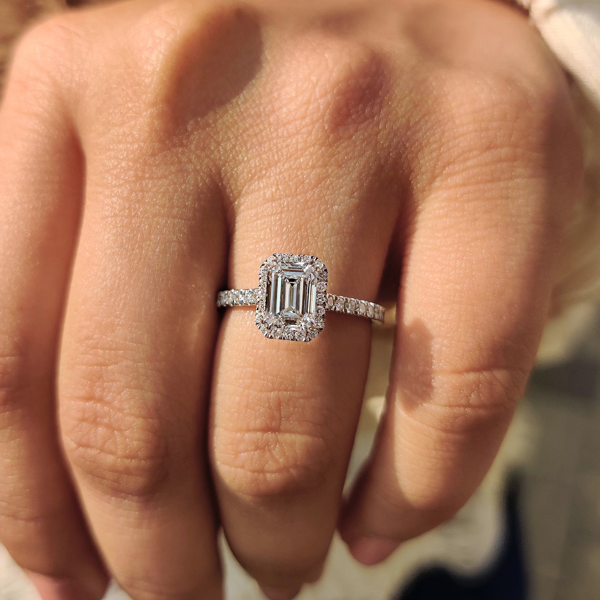 Emerald cut diamond ring with halo design
