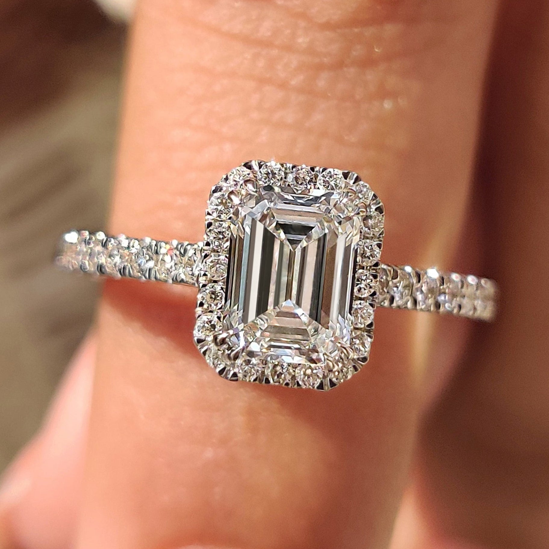 Emerald halo engagement ring avaiable in every metal.
